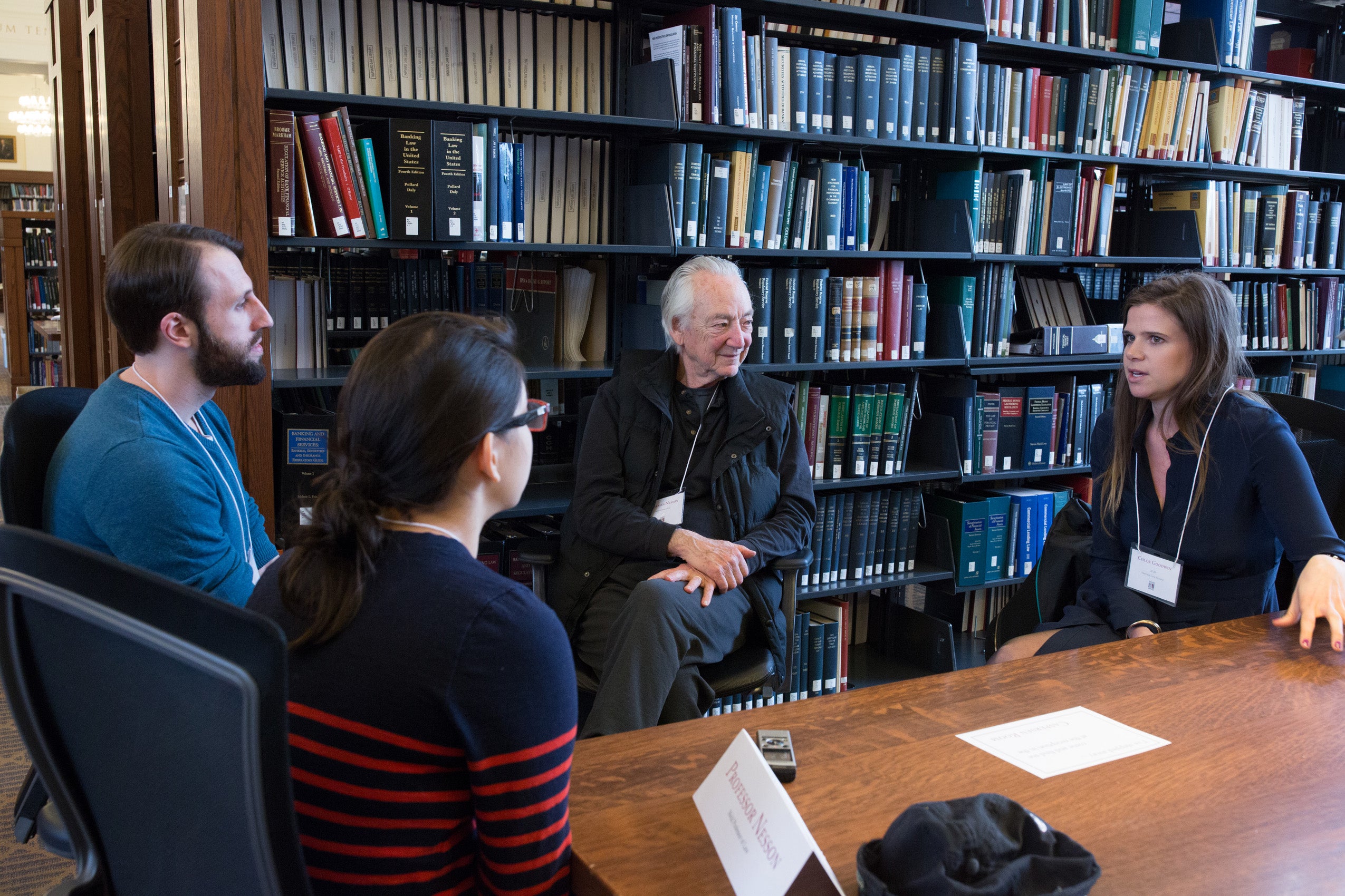 A group of two men and two women sitting together having a conversation