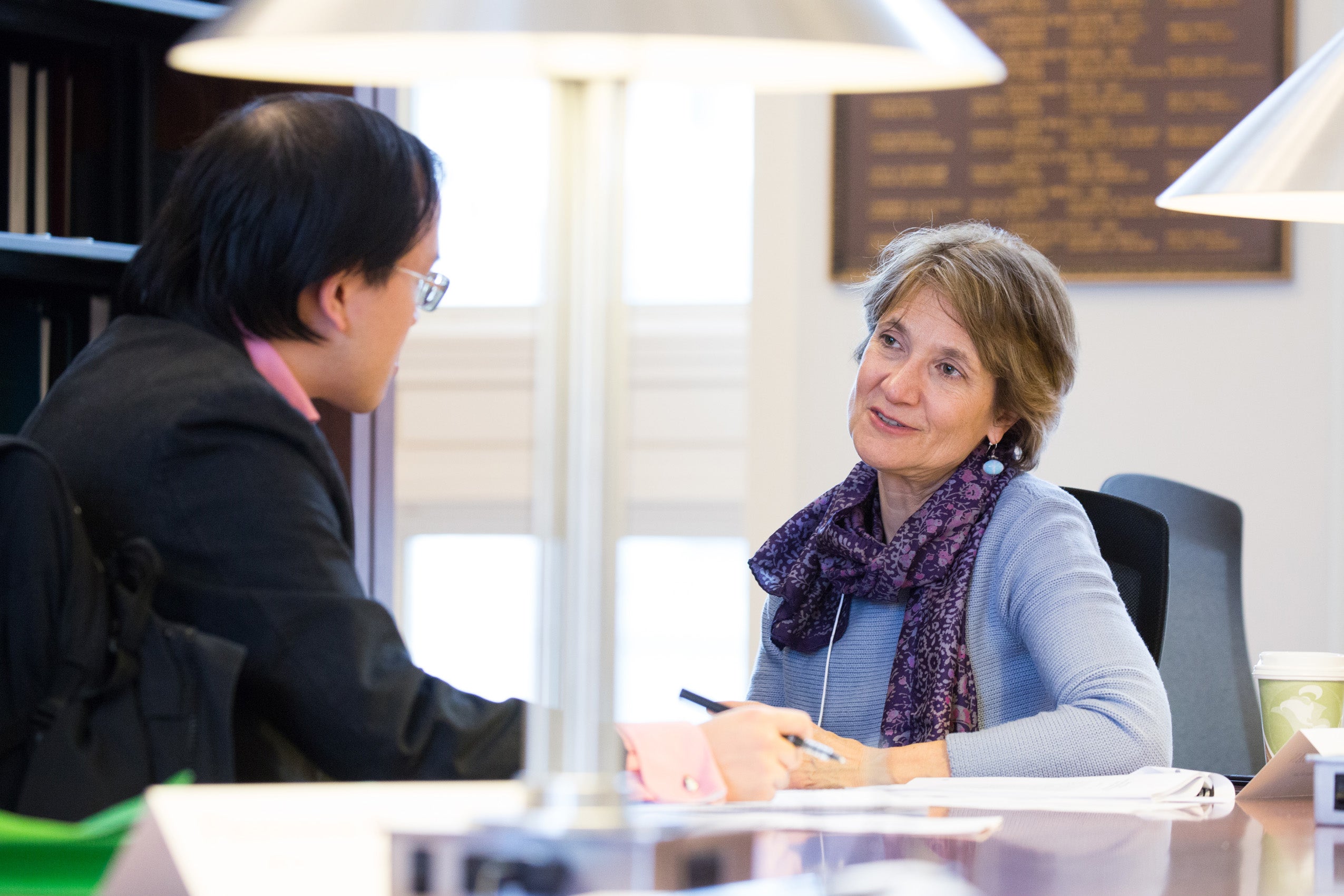 A man and a woman sitting at a table having a conversation