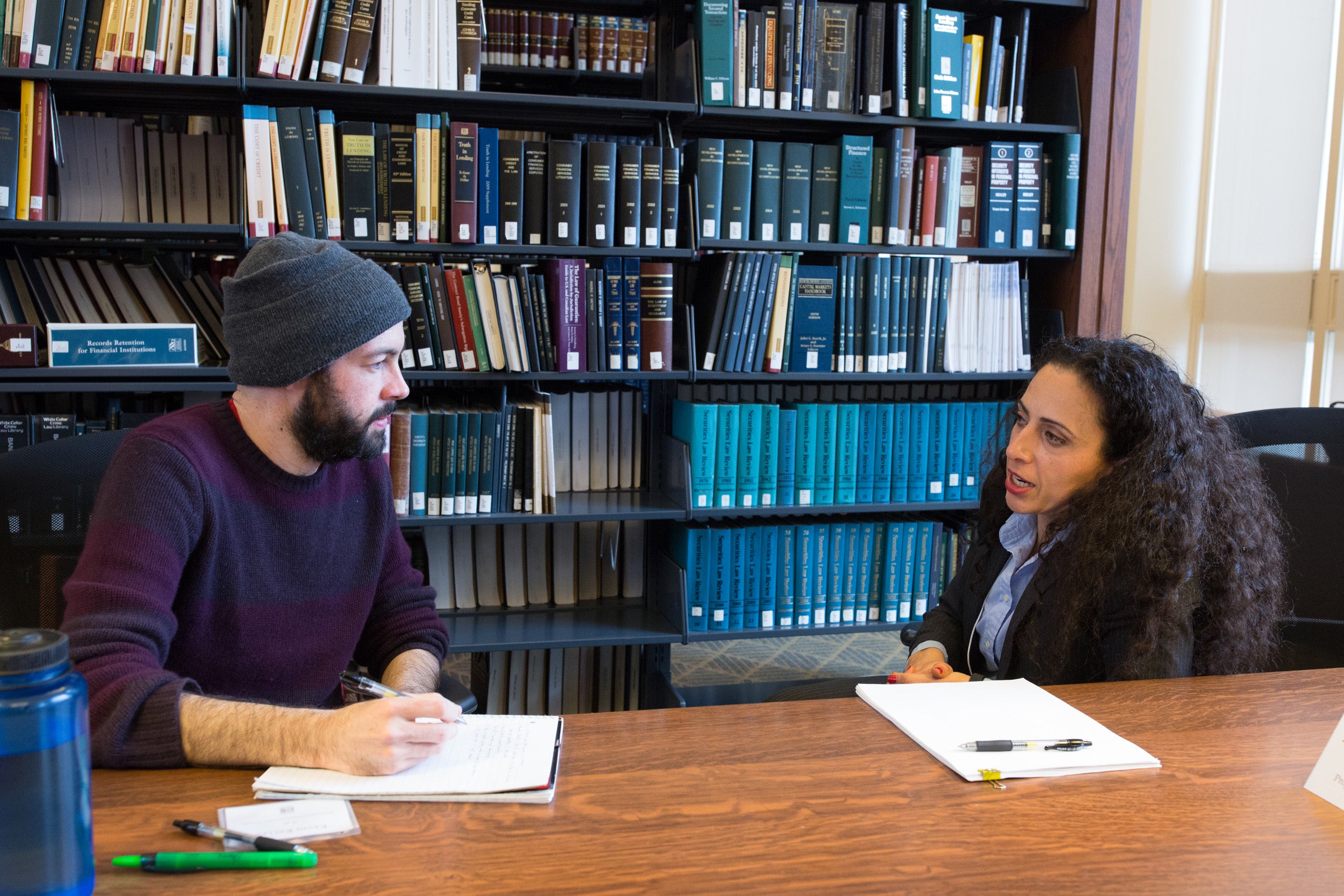 A man and a woman sitting at a table having a conversation