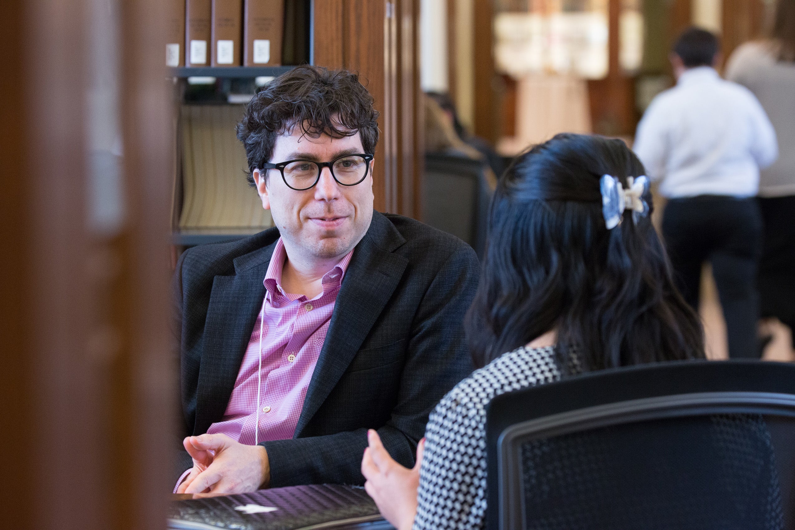 A man and a woman seated, having a conversation