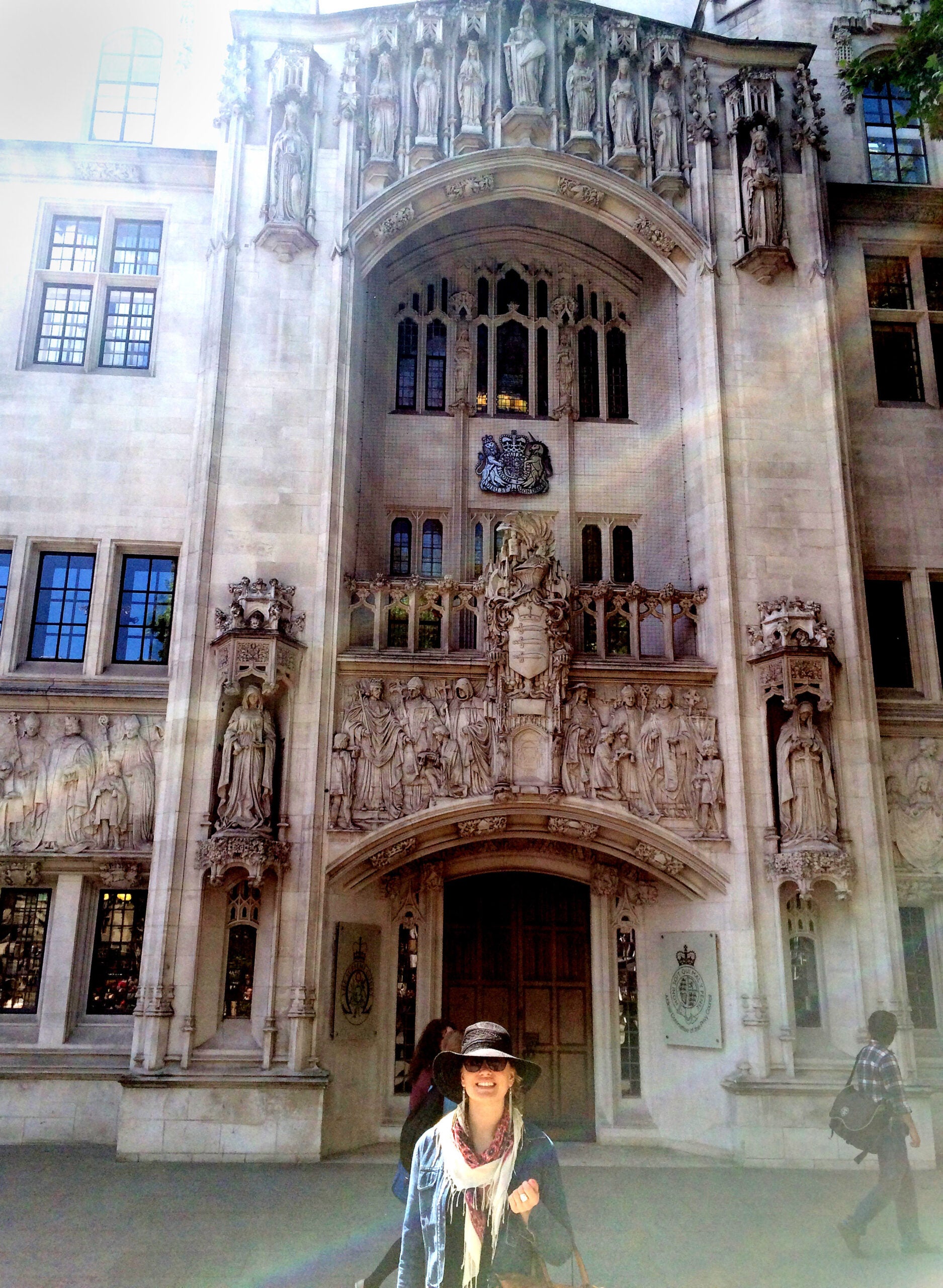 A woman standing and smiling in front of a Cathedral
