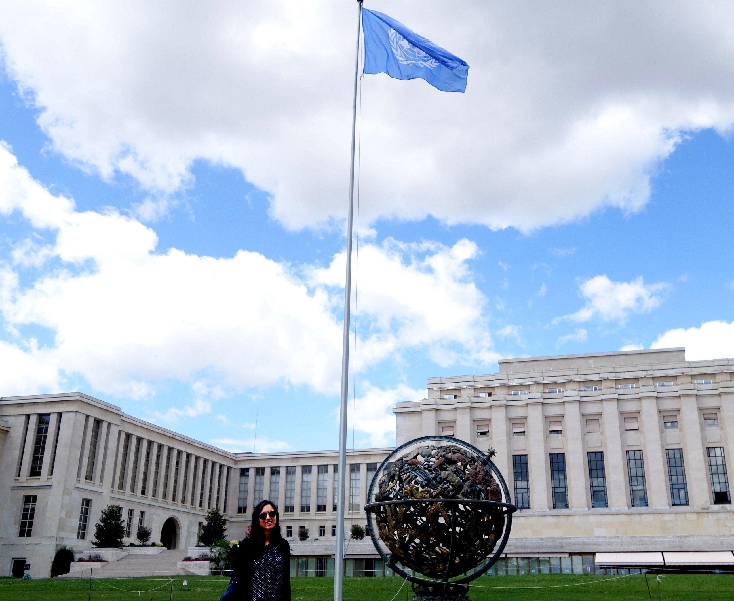 A woman standing in front of a large building
