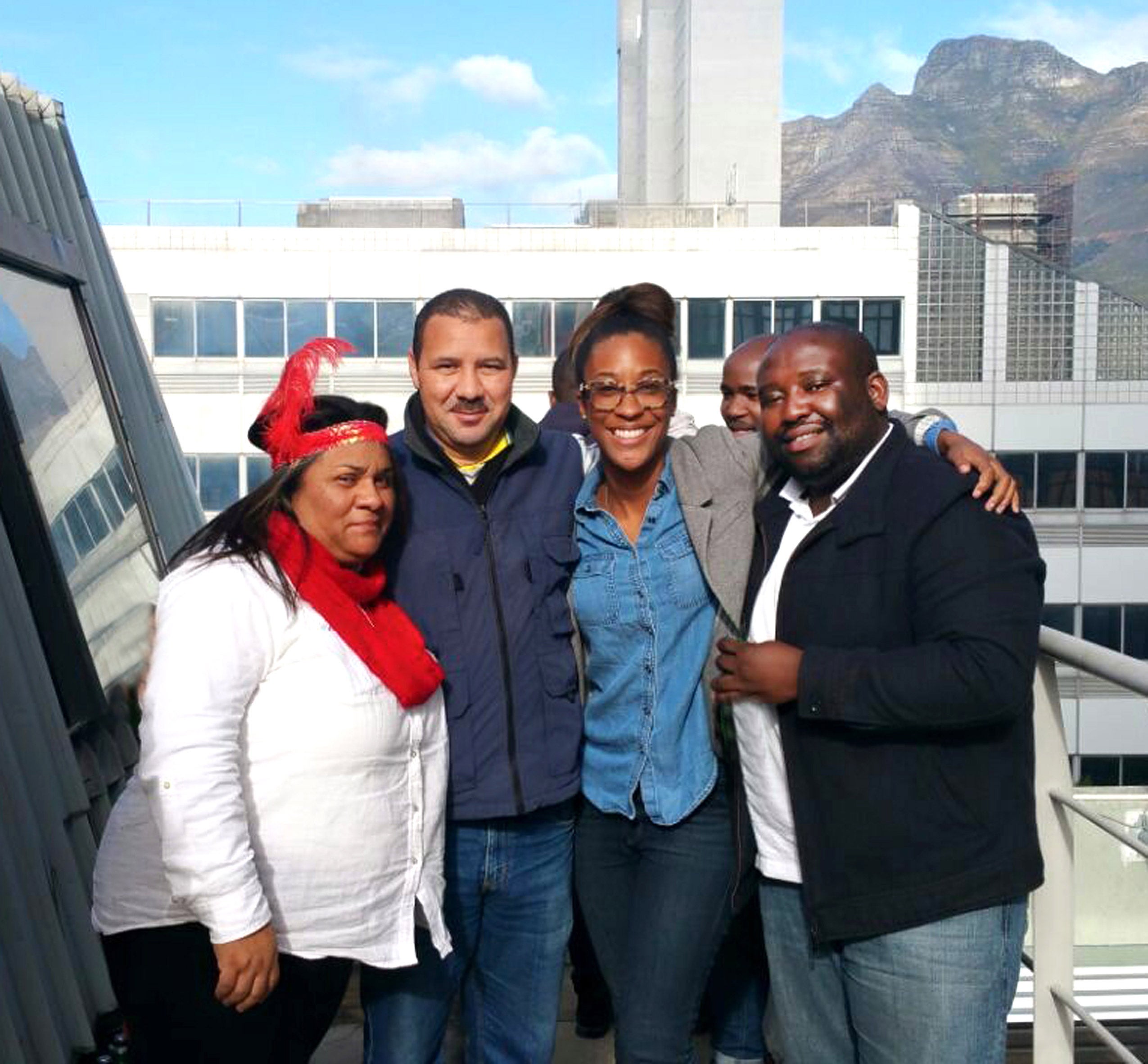 A group of people standing and smiling