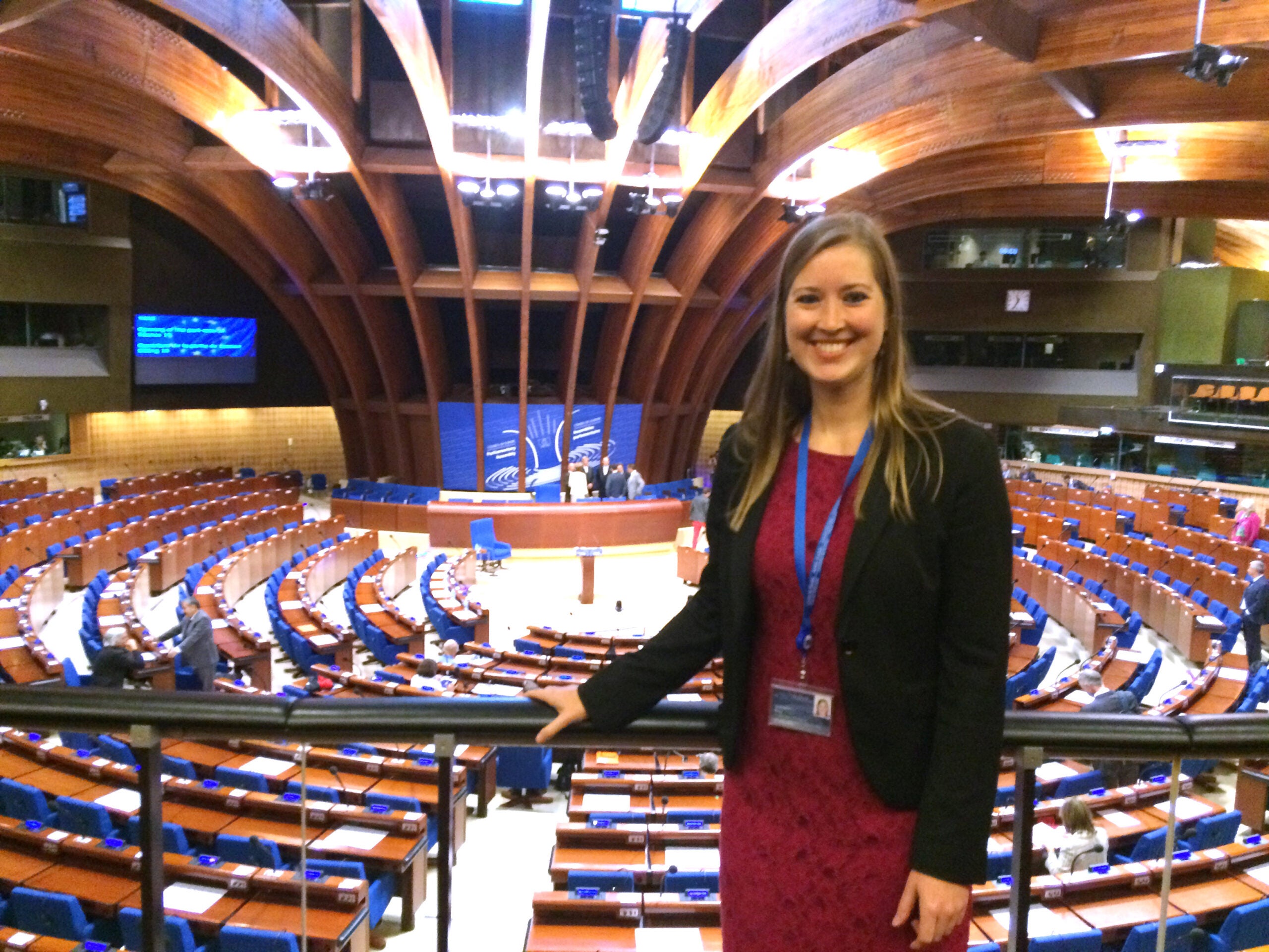 A woman posing in front of a Parliamentary Assembly