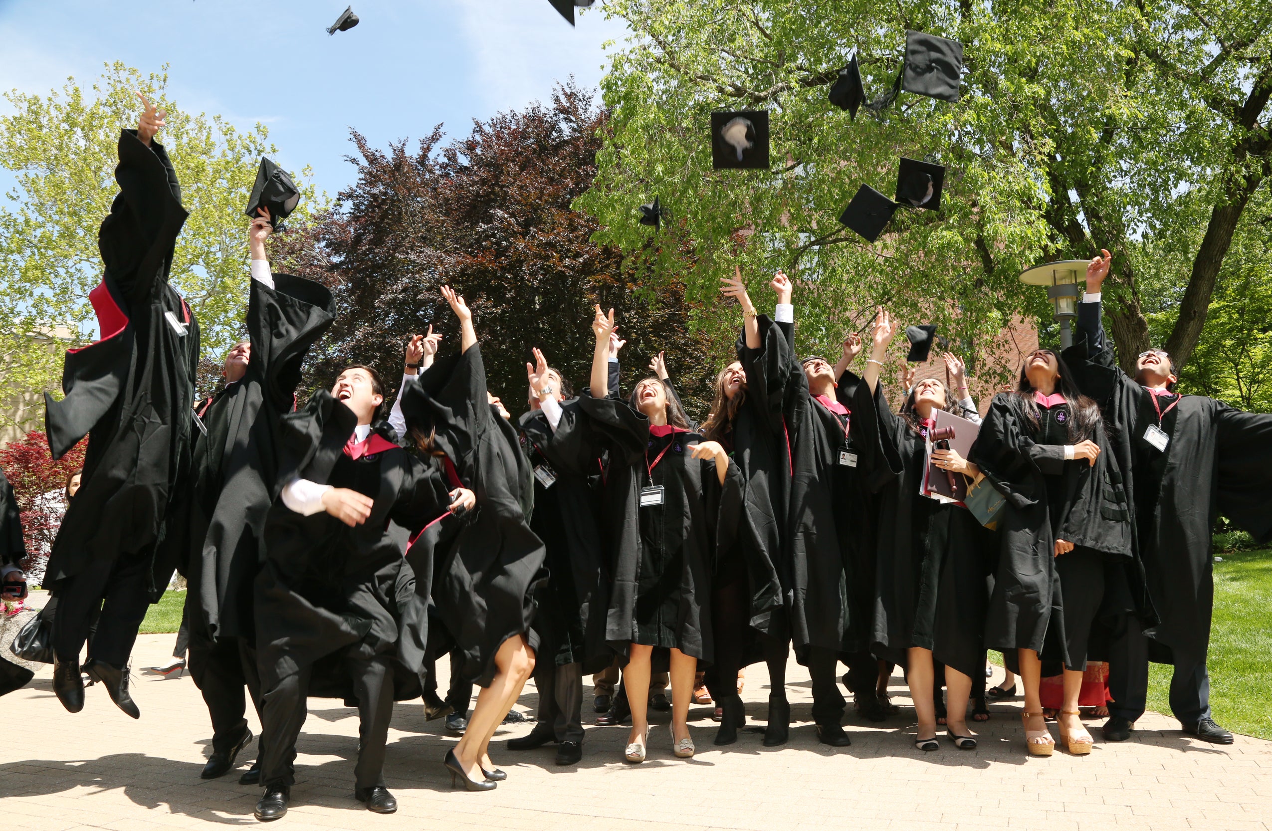 A group of graduates tossing their caps into the air