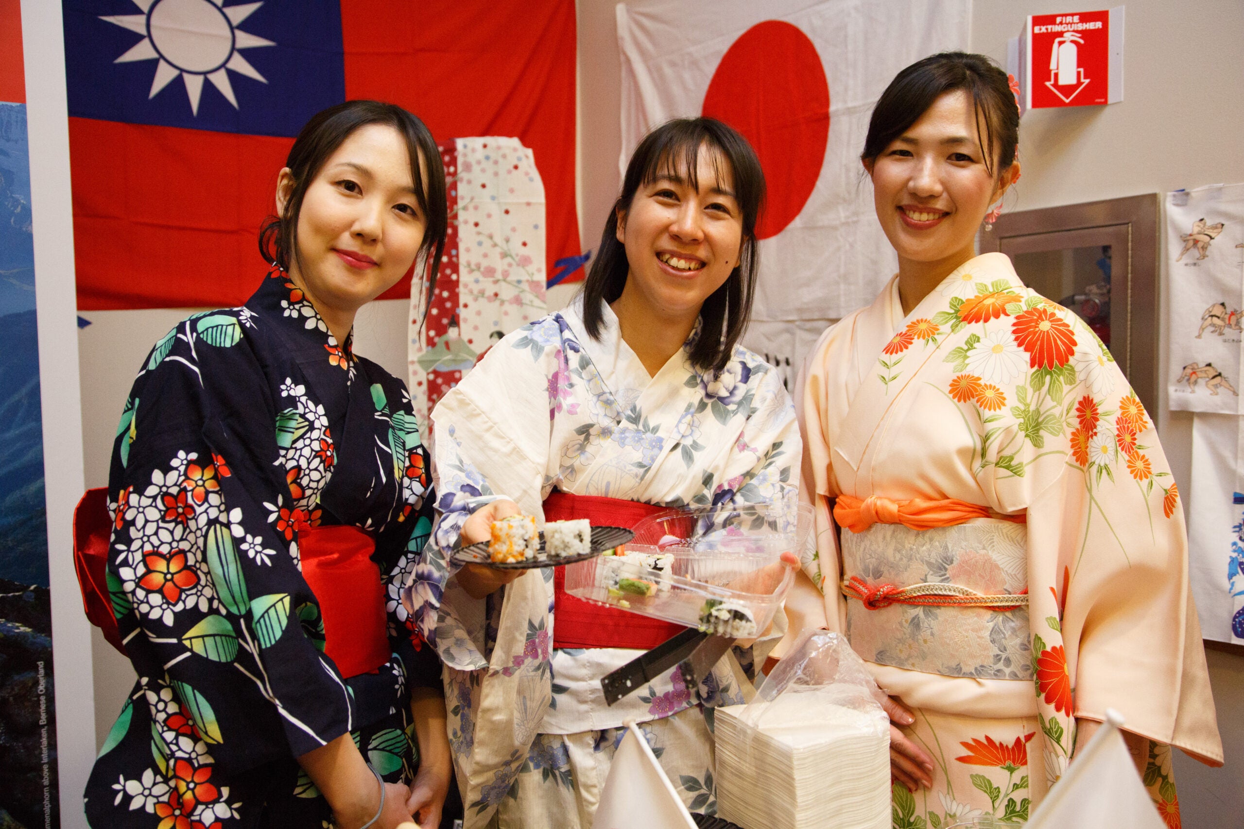 Three women posing together in traditional dress