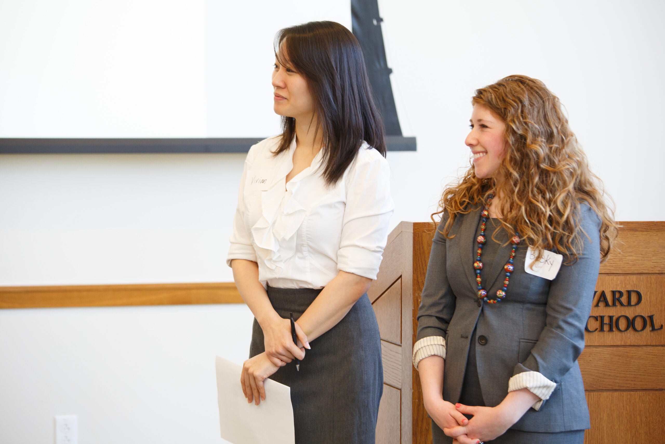 Two women standing together, smiling