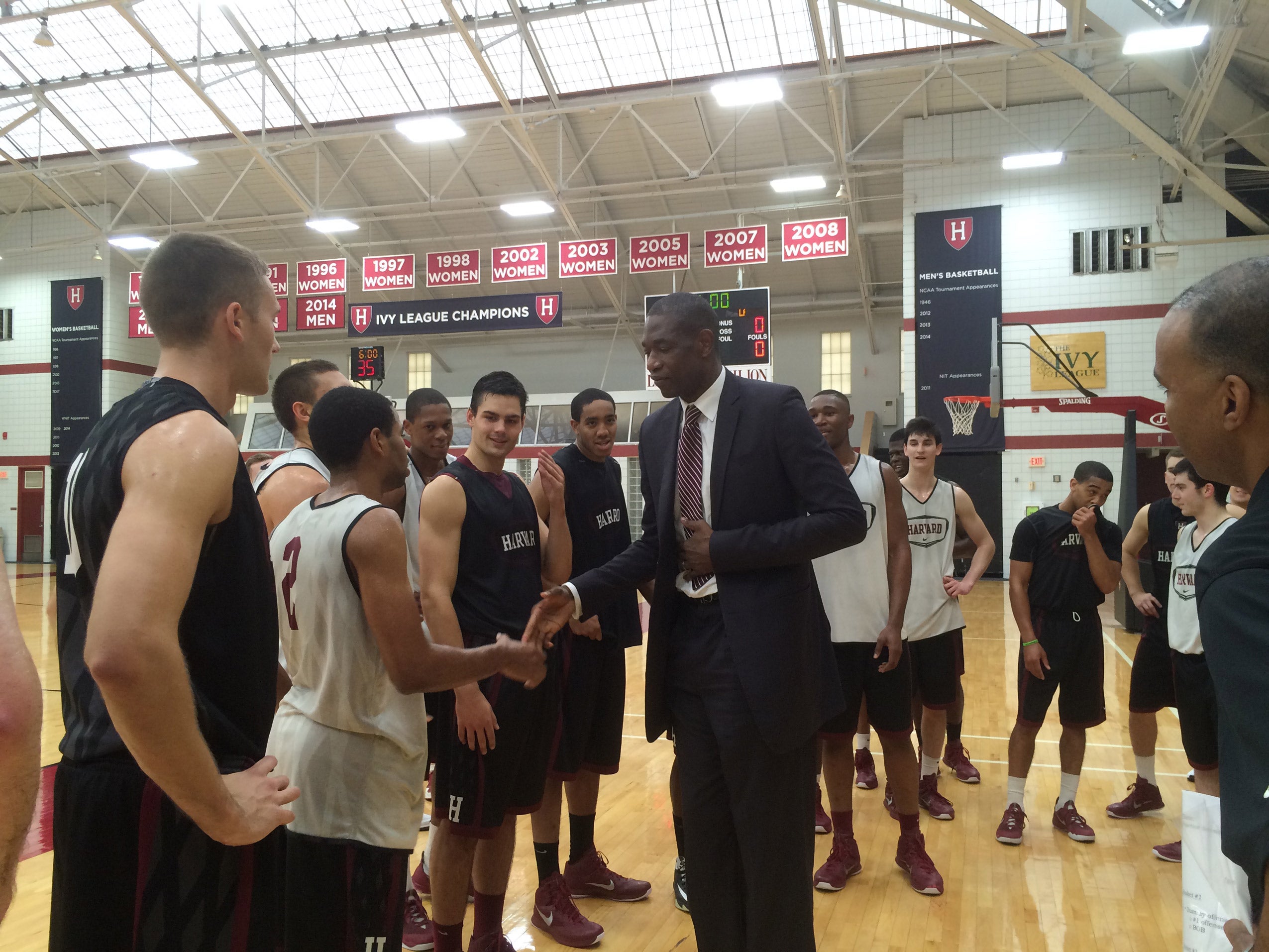 A man shaking hands with a basketball team