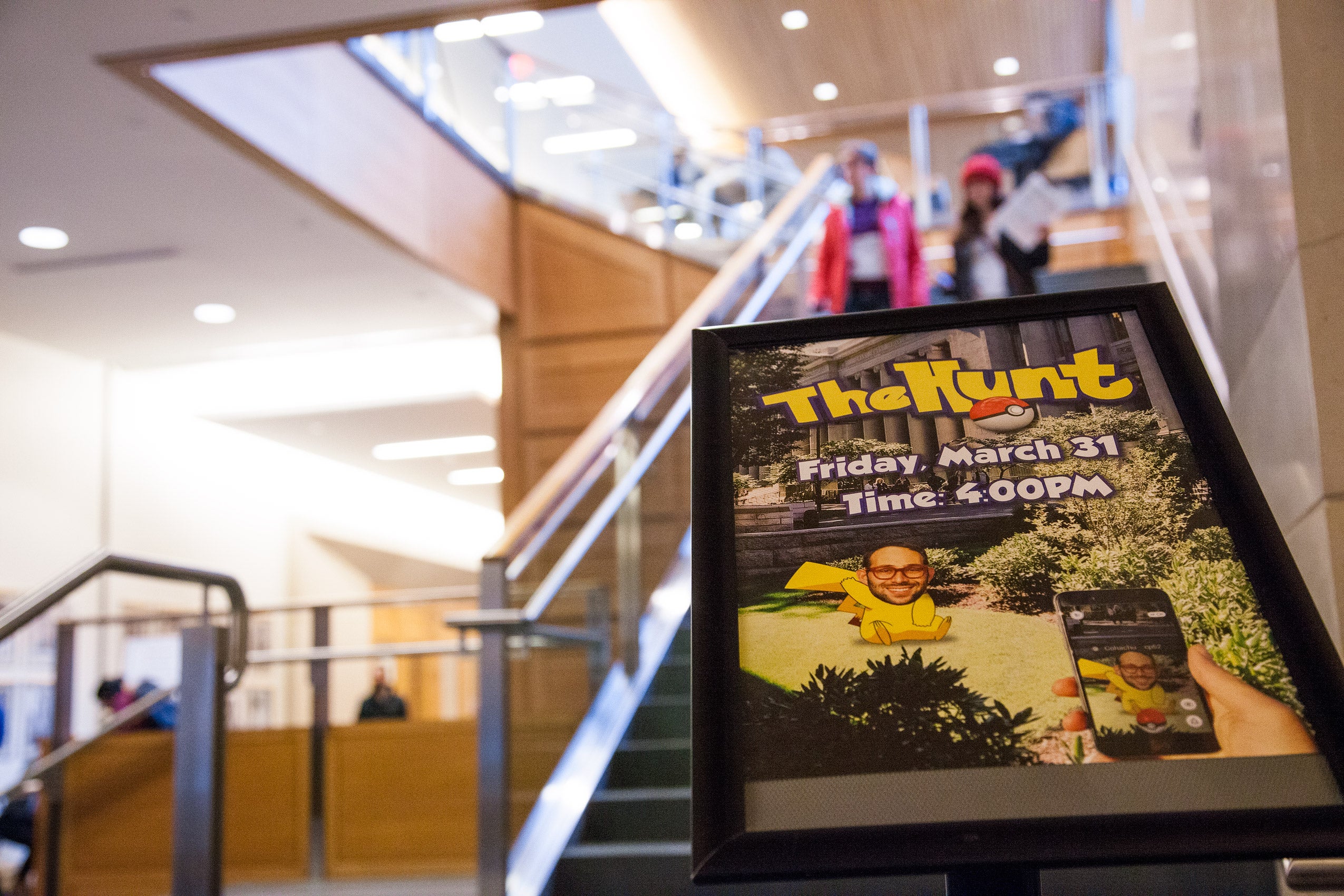 A flyer in front of a set of stairs that advertises 'The Hunt'