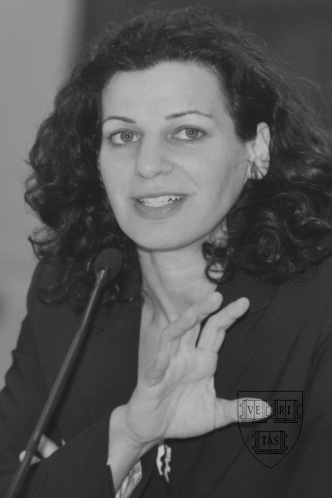 Black and white photo of a woman speaking into a microphone