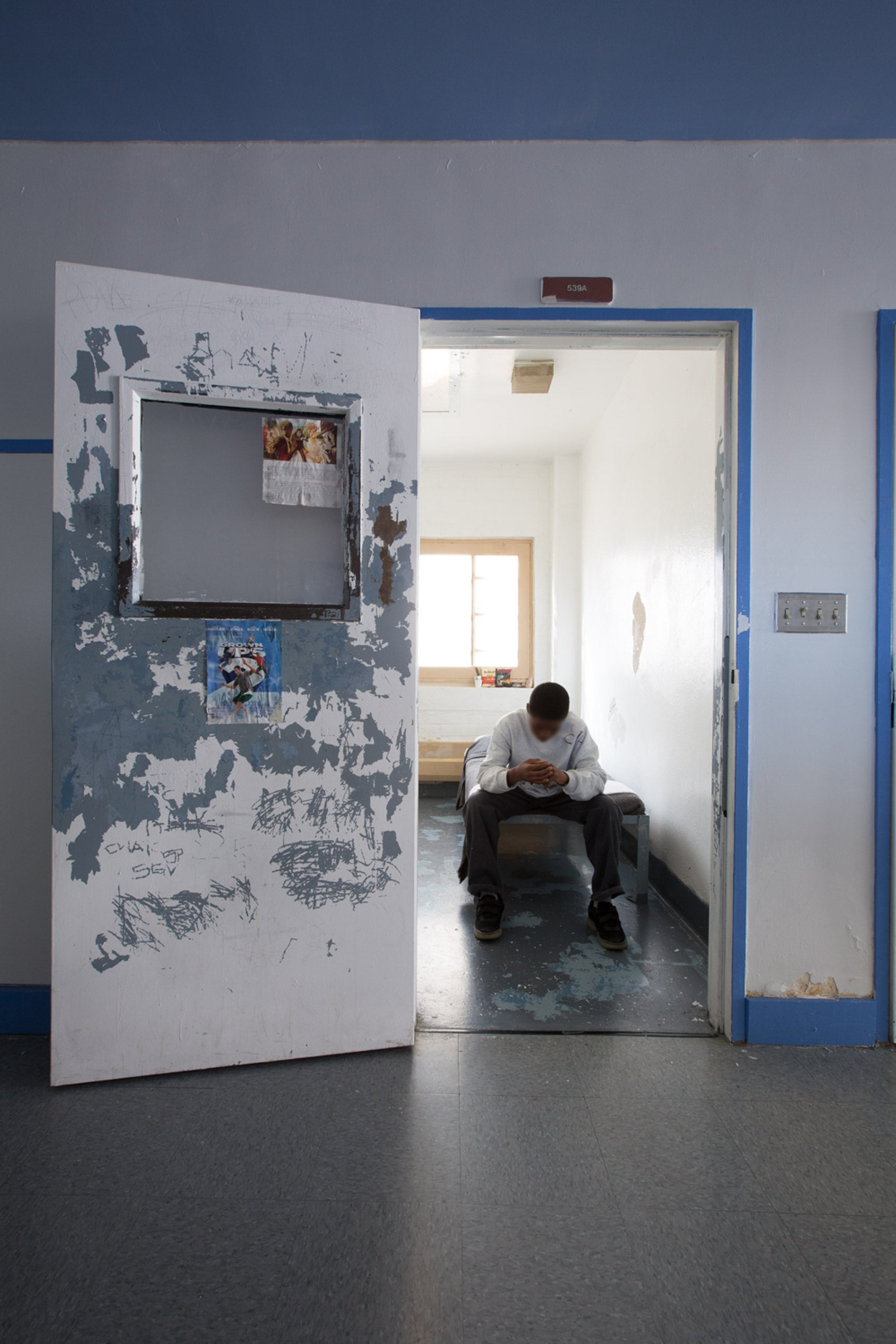 A boy in a prison cell