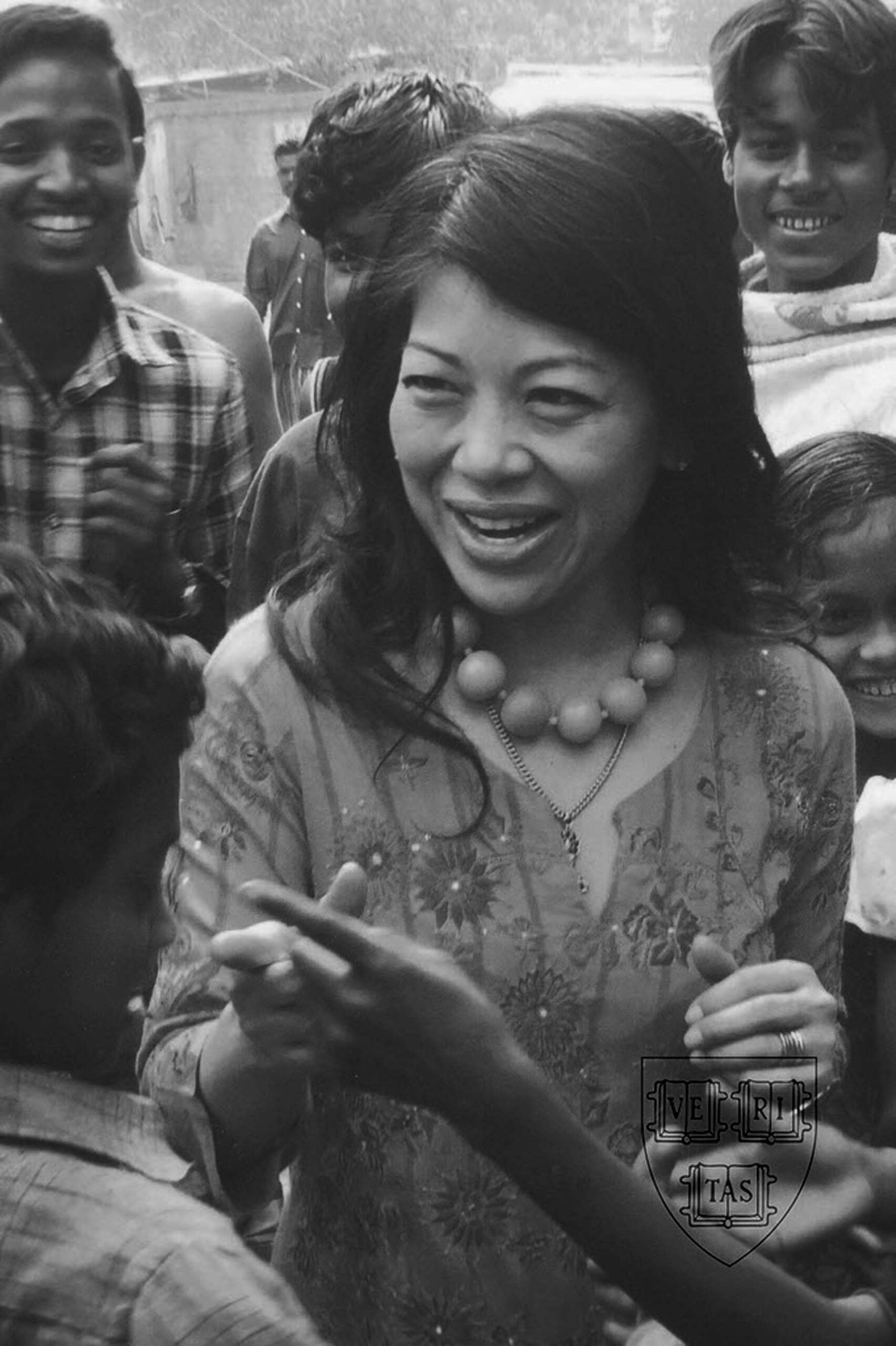 Black and white photo of a woman surrounded by children