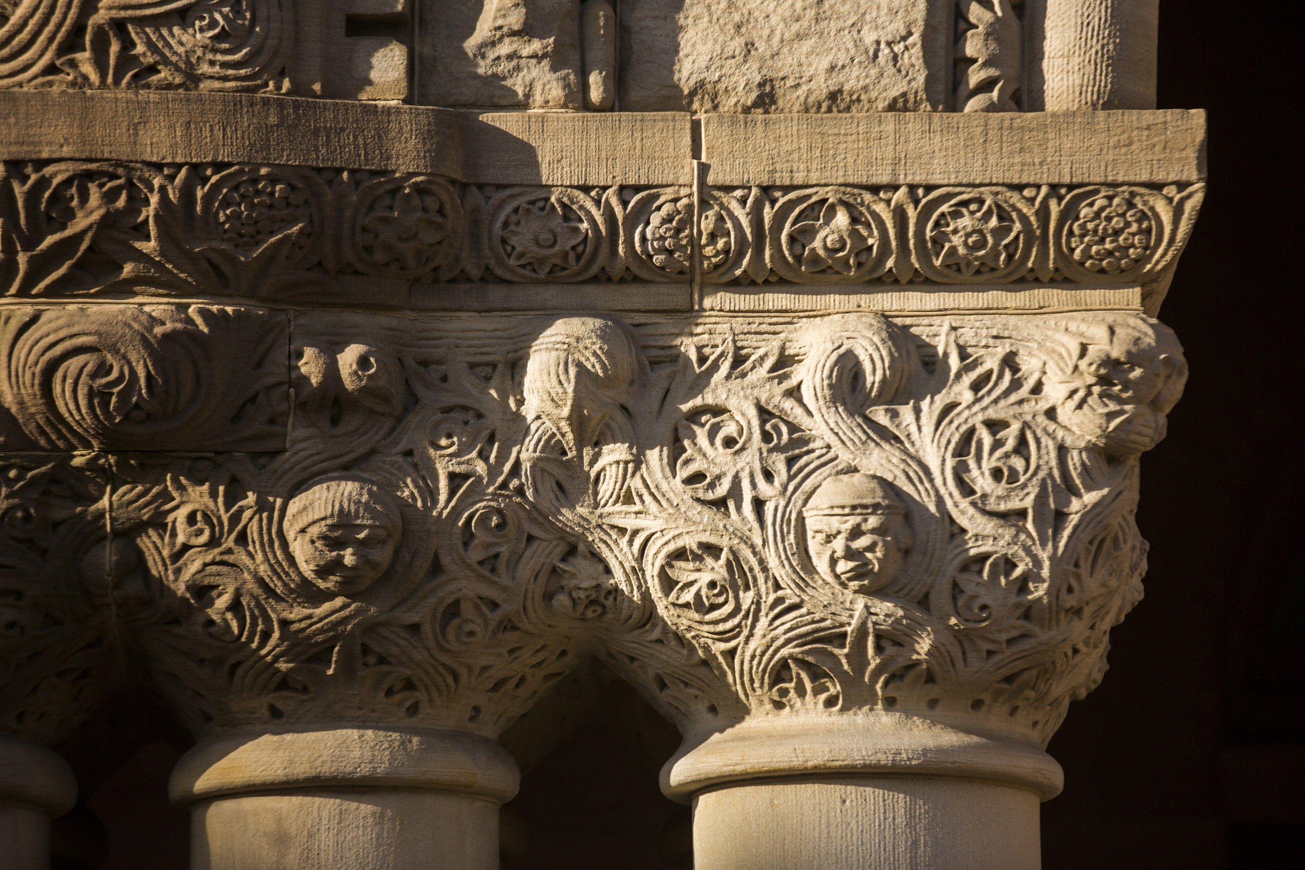 Close up of the faces carved into the pillars of Austin Hall