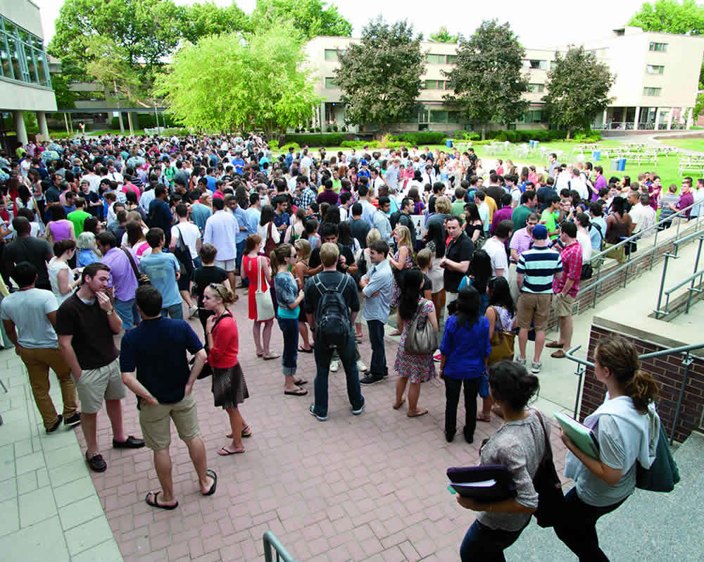 huge groups of students standing outside Harkness Commons