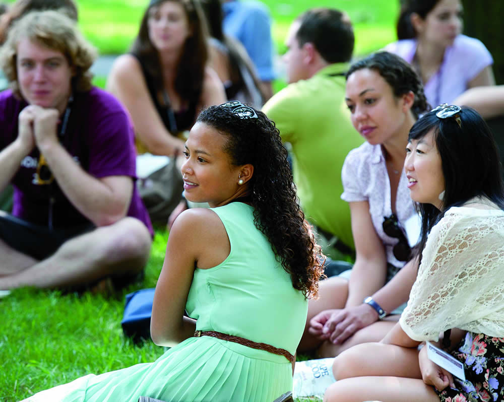 students sitting on the grass