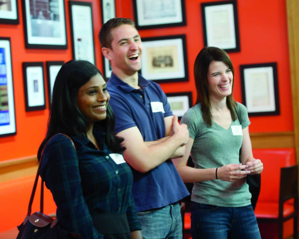three students smiling and laughing