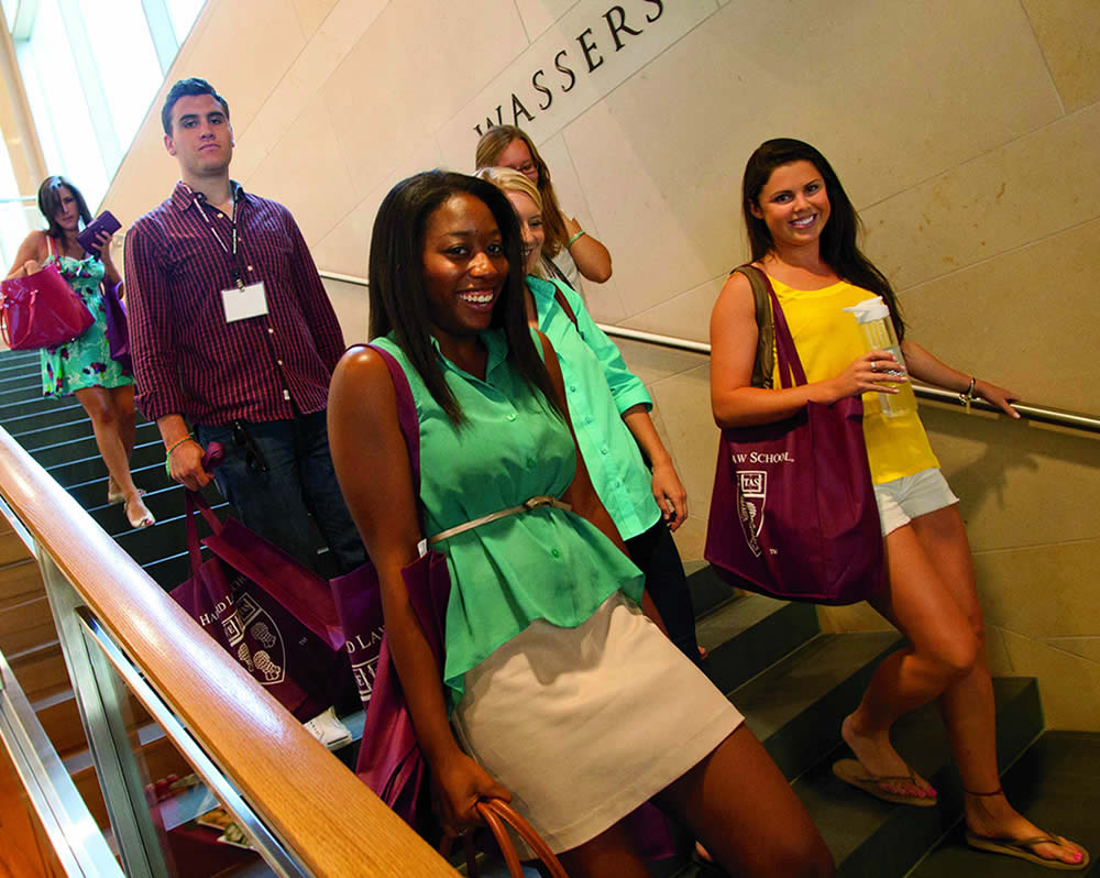 group of people walking down stairs, smiling