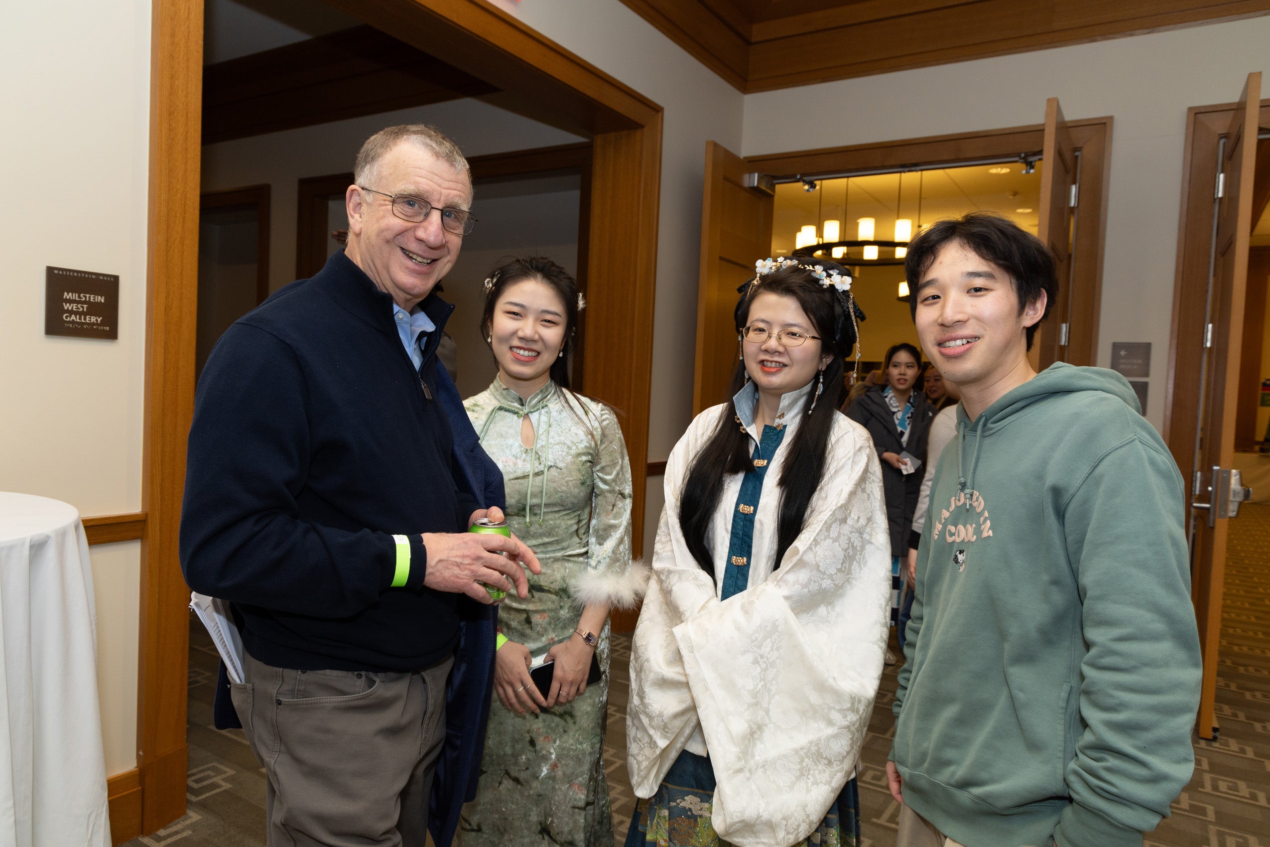 Professor Alford with three students at an event