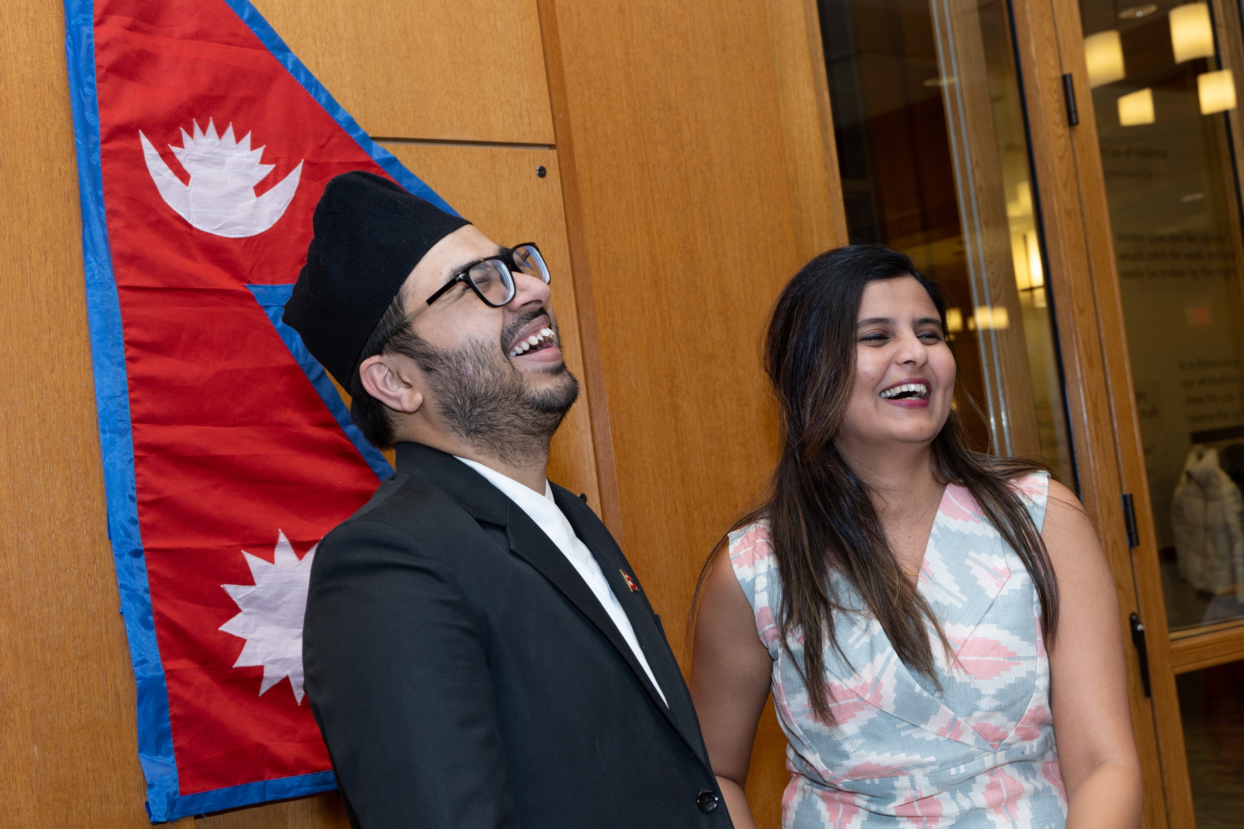 A man and a woman at event enjoying a light moment