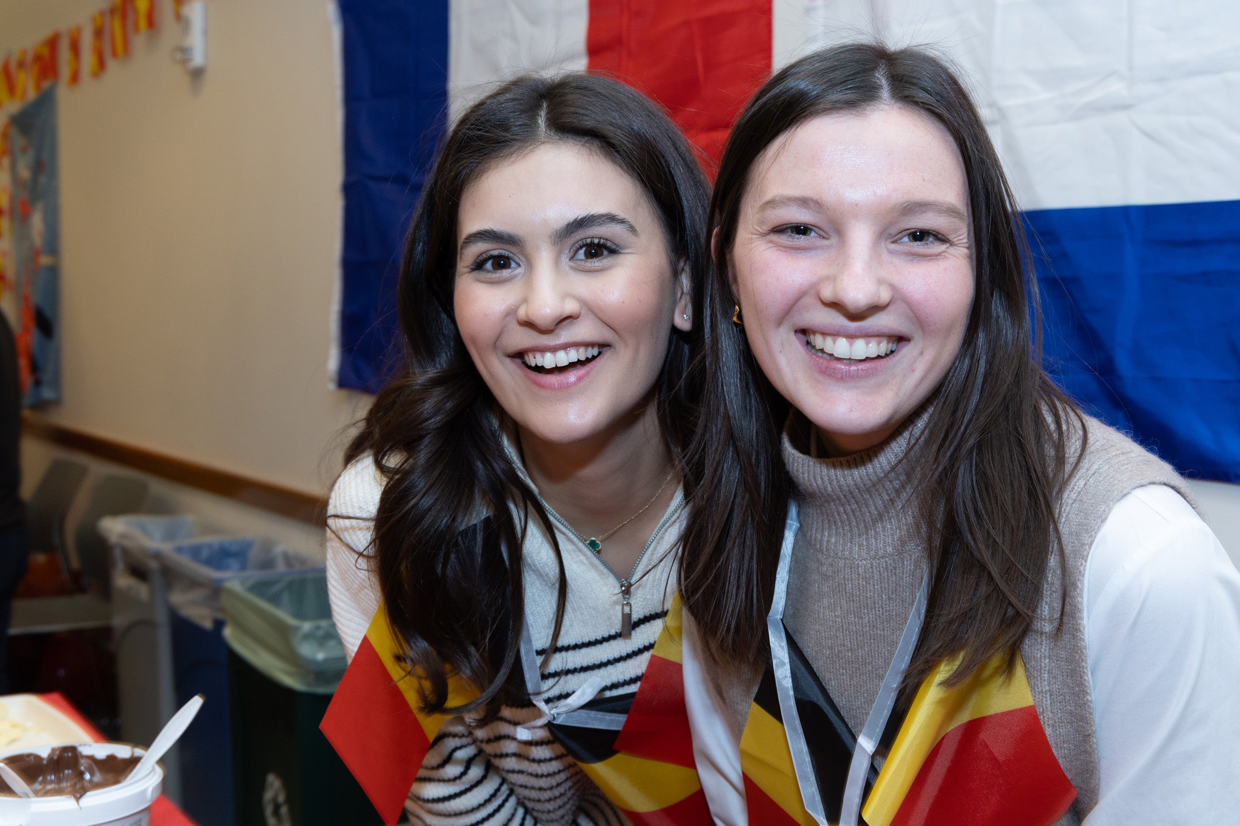 Two women post for a close up photo at an event