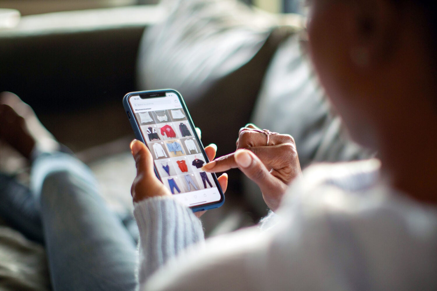 Woman purchasing clothes on a mobile app.