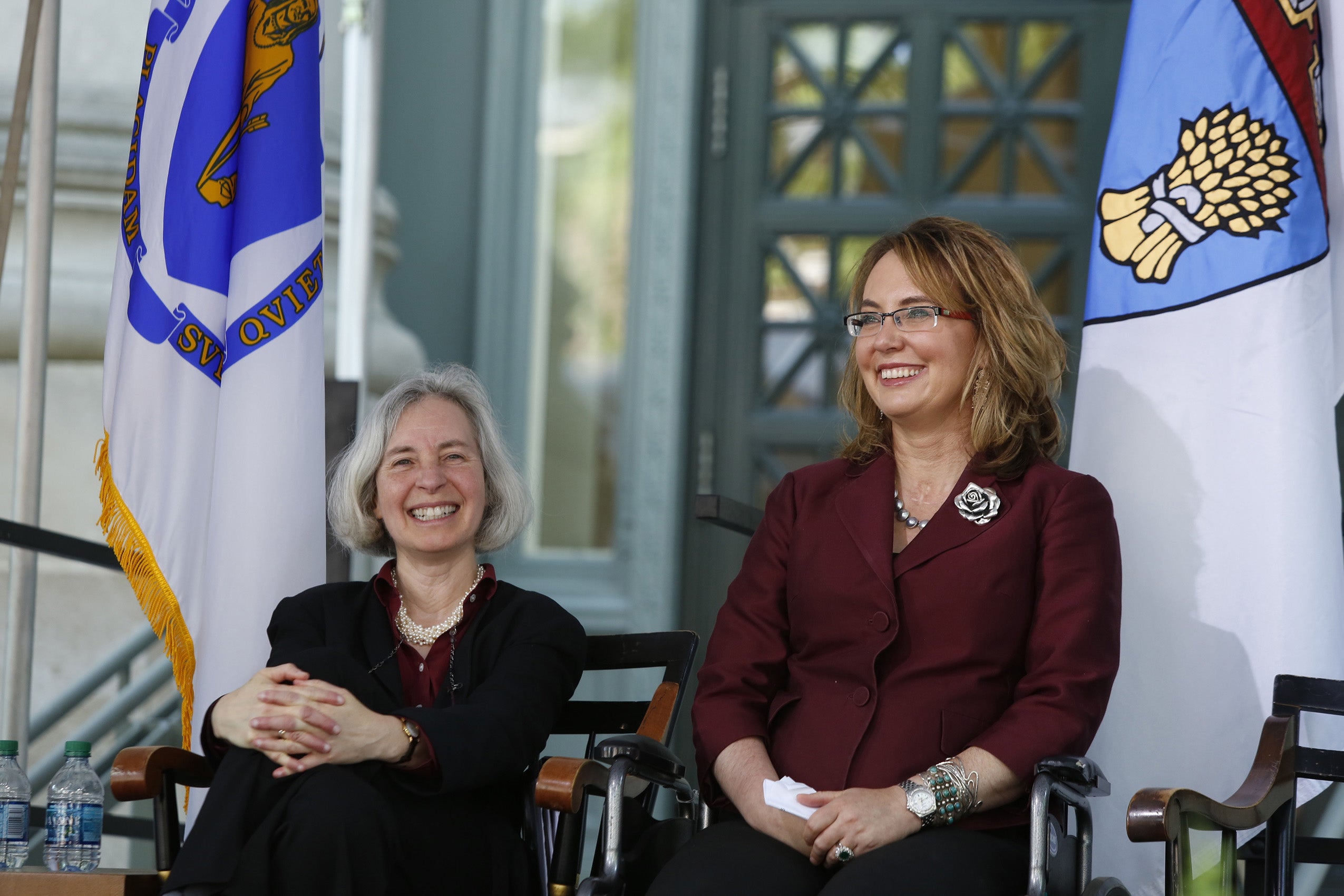 Two women smiling on stage