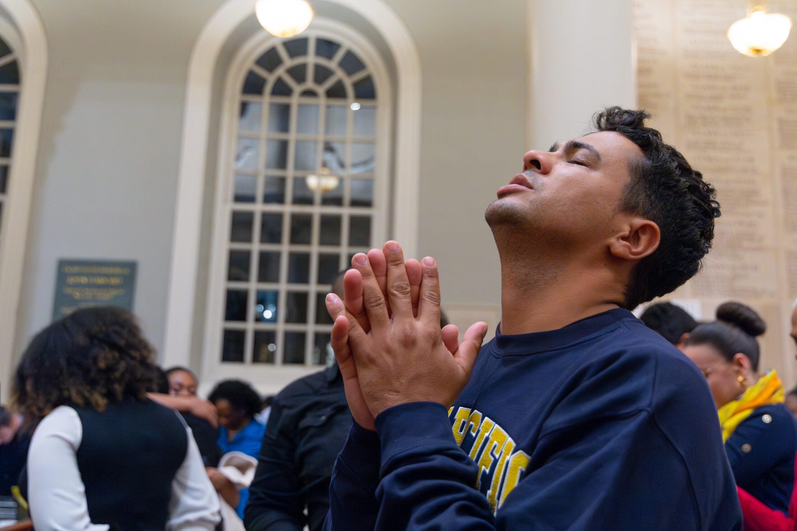 Man prays with head tilted upward