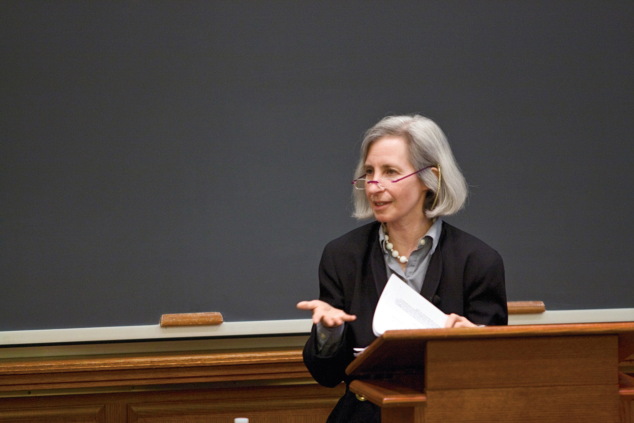 Martha Minow holding paper at podium