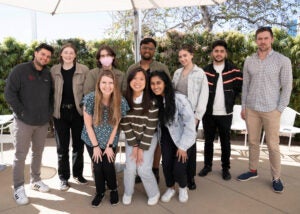 a group of ten students pose for a photo outdoors
