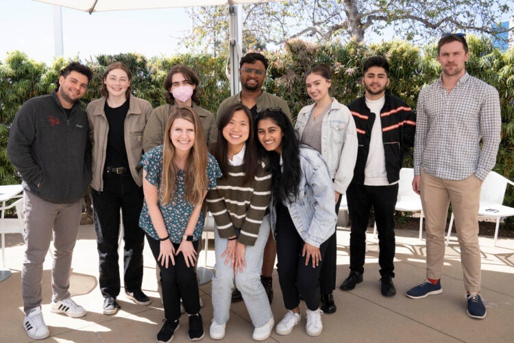 a group of ten students pose for a photo outdoors