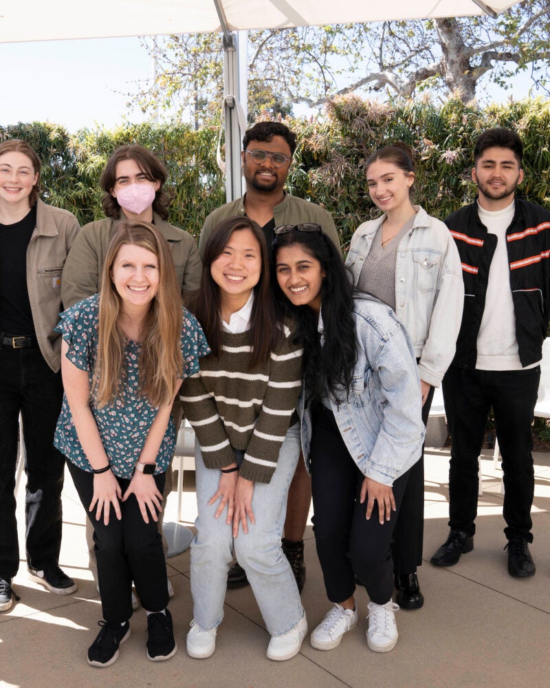 a group of ten students pose for a photo outdoors