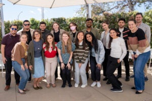 a group of students and staff pose for a photo outdoors