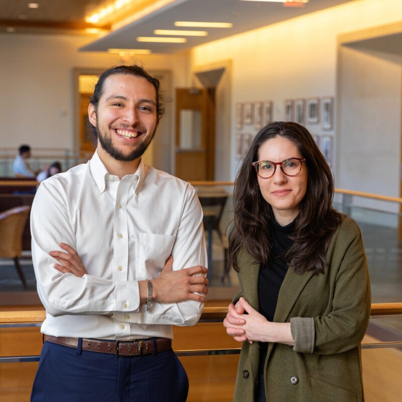 Two students pose for a photo in a WCC hallway