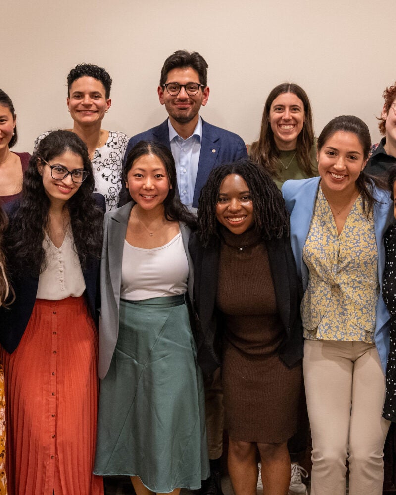A group of 14 students pose for a photo
