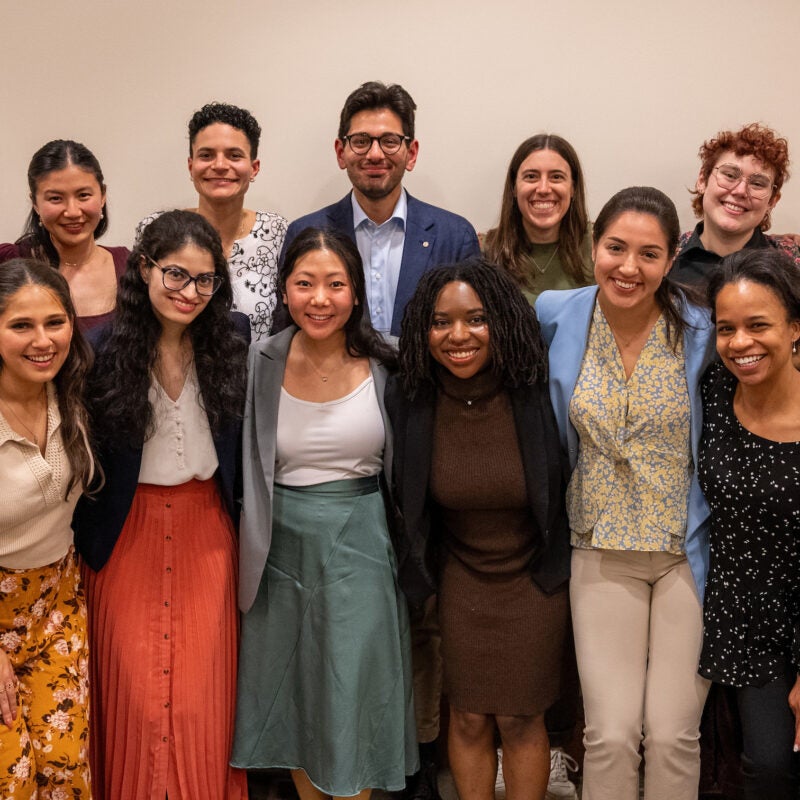 A group of 14 students pose for a photo