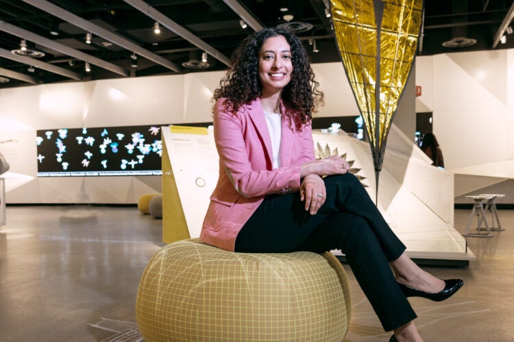 Portrait of woman sitting on a soft pillow in a museum