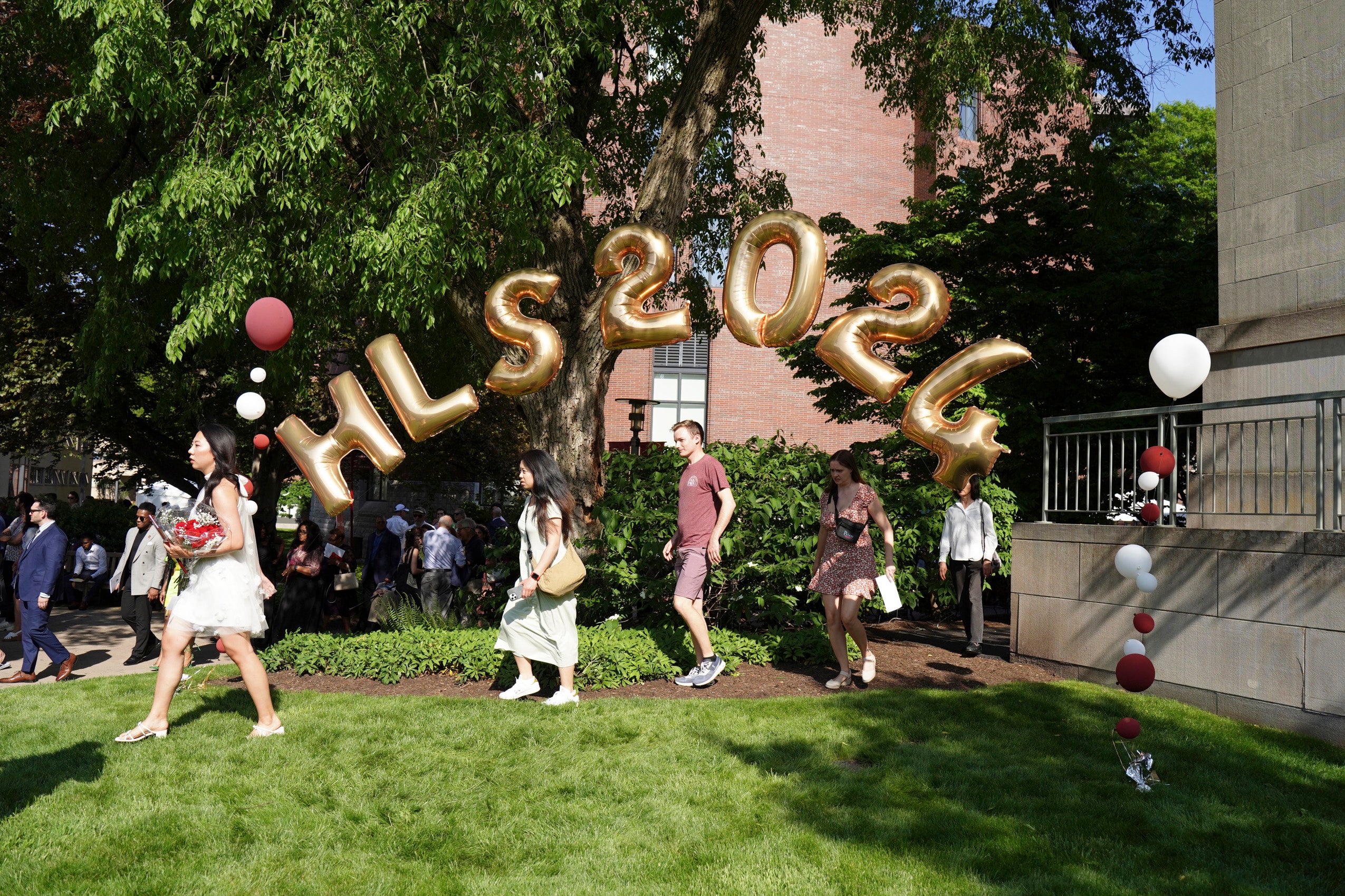 Students and family walking beneath the HLS 2024 balloons