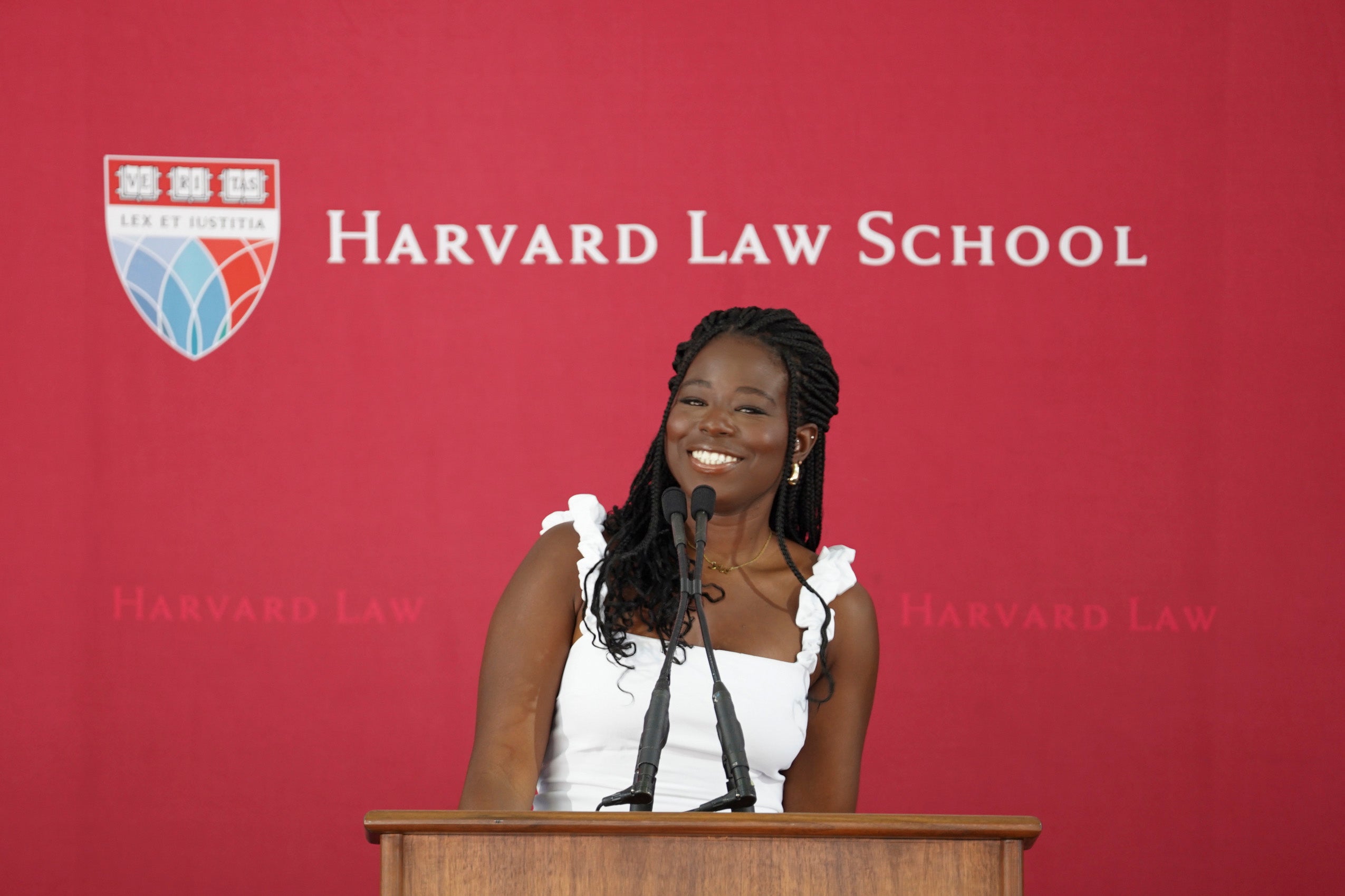 A woman standing at a podium smiling