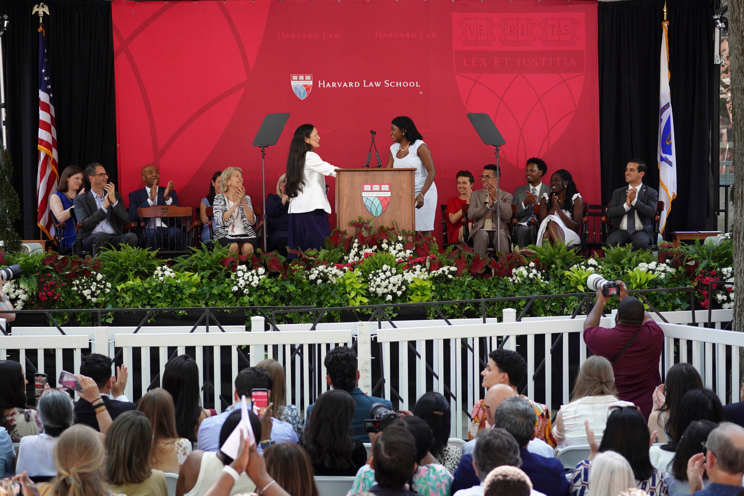 The audience and speakers listening to the program