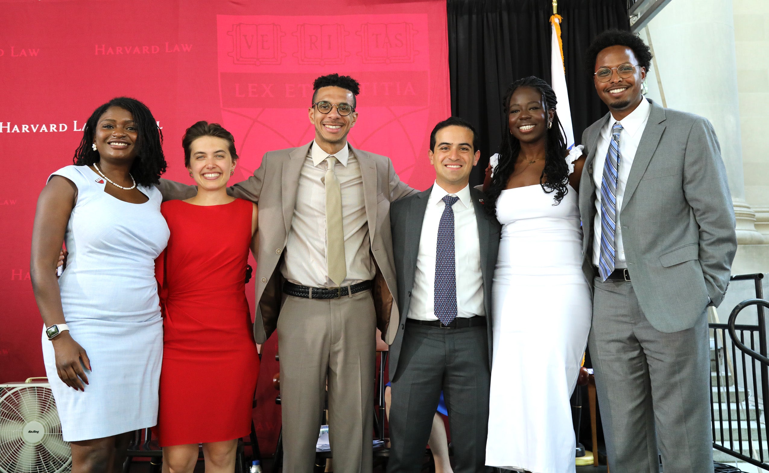 Graduating students smiling and posing together