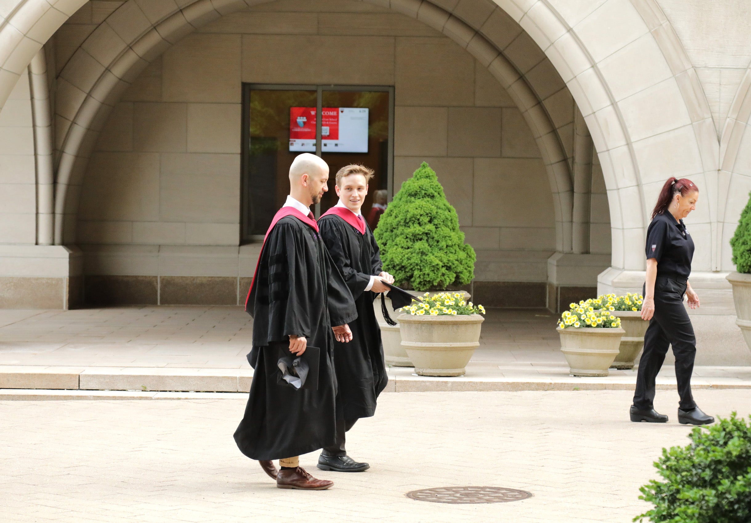 Two men in their gowns walking together