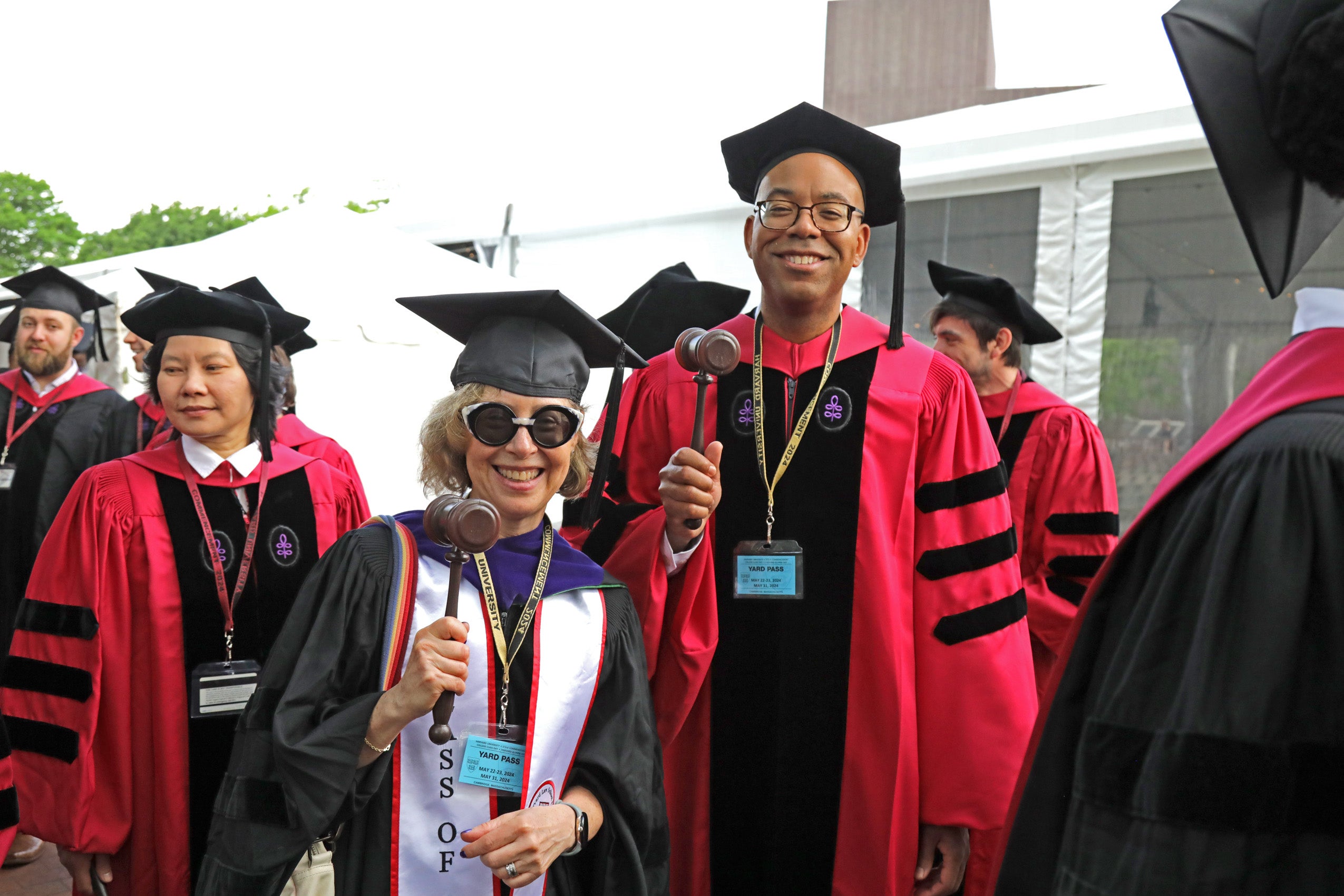 Two people standing and smiling, holding their gavels up