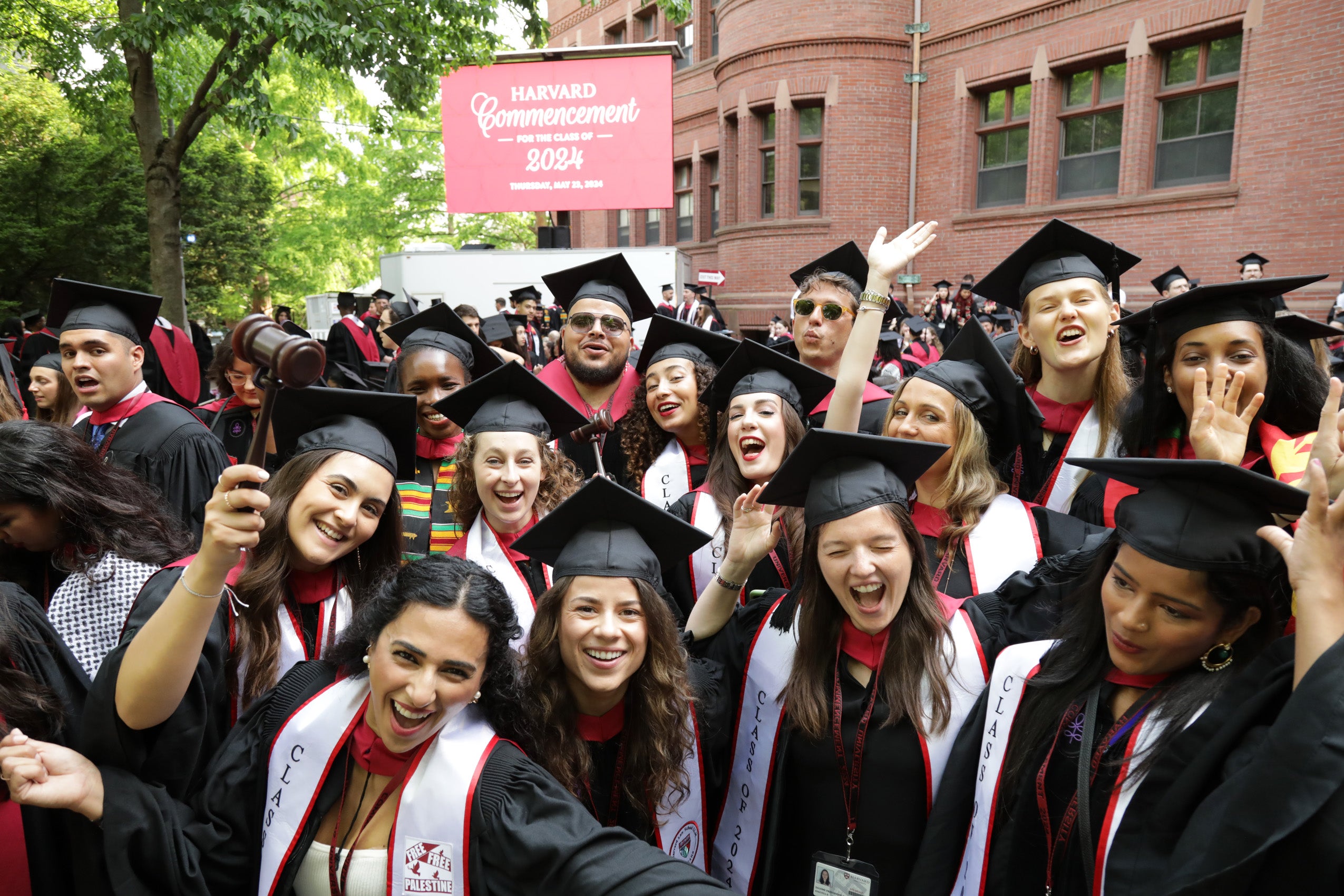 A group of graduating students smiling and cheering