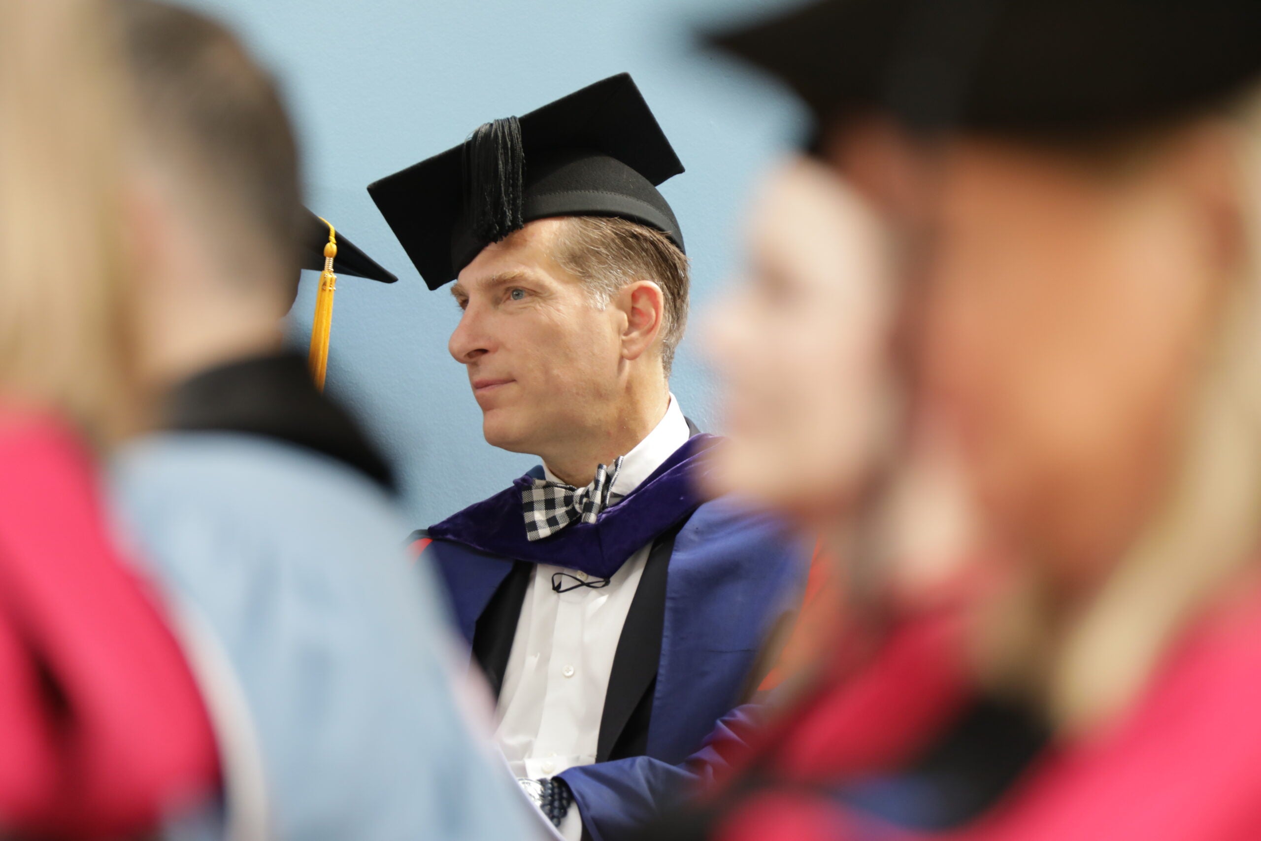 Faculty member in regalia on stage