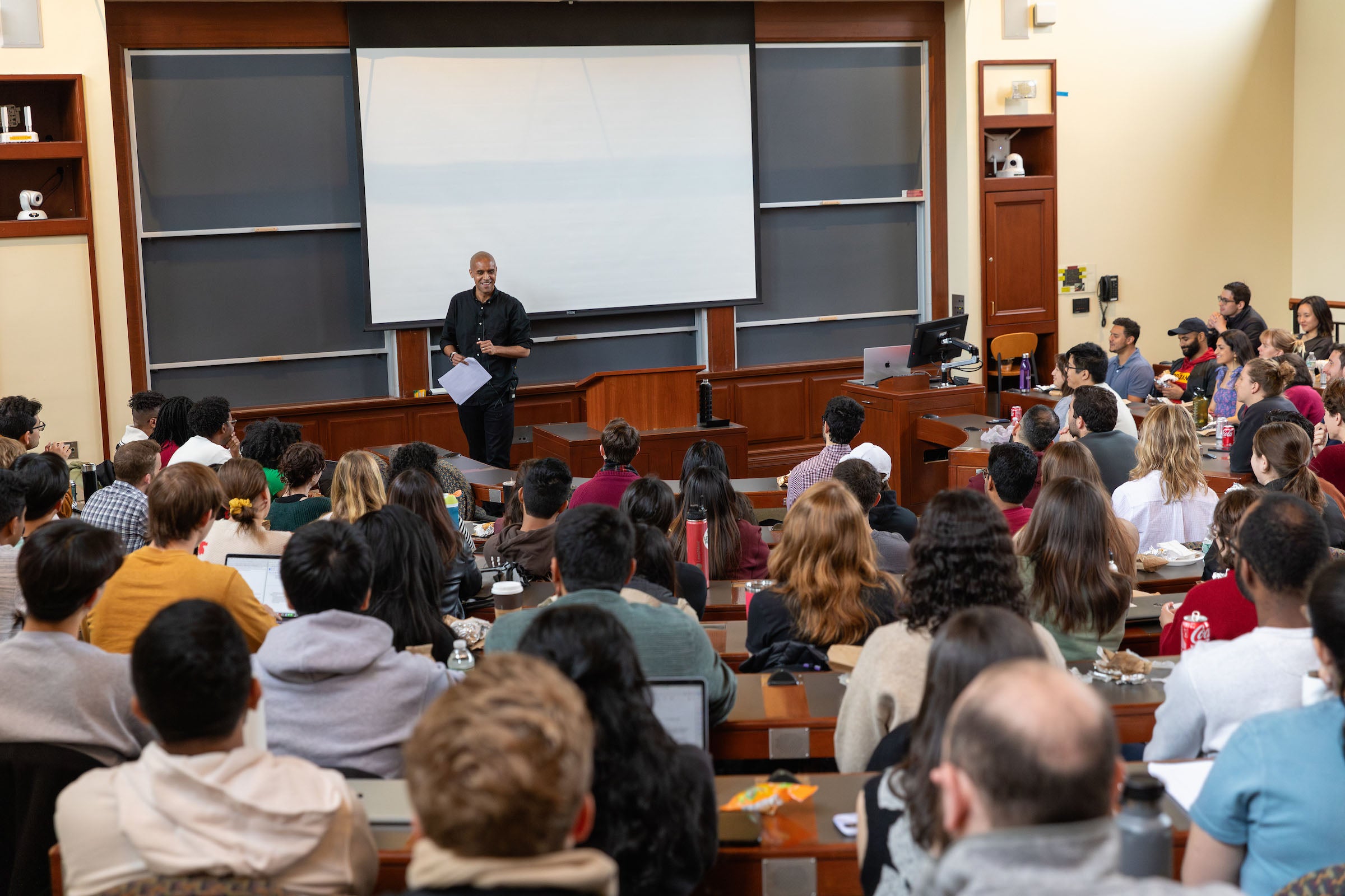 Nikolas Bowie standing in front of a full classroom of students