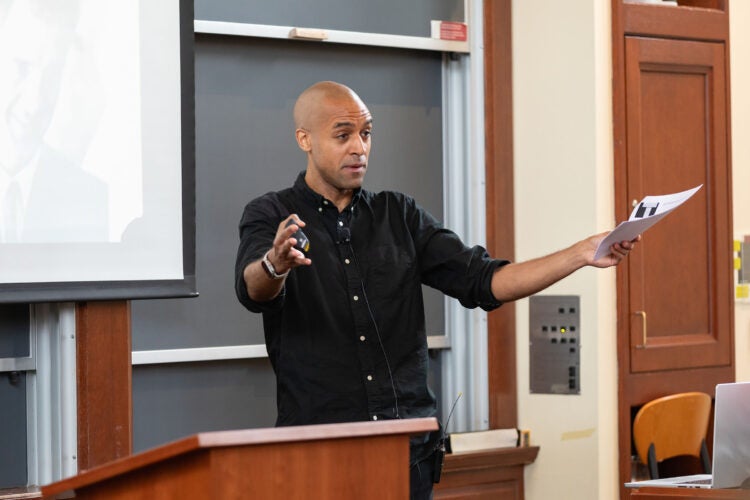 NIkolas Bowie speaking near a podium