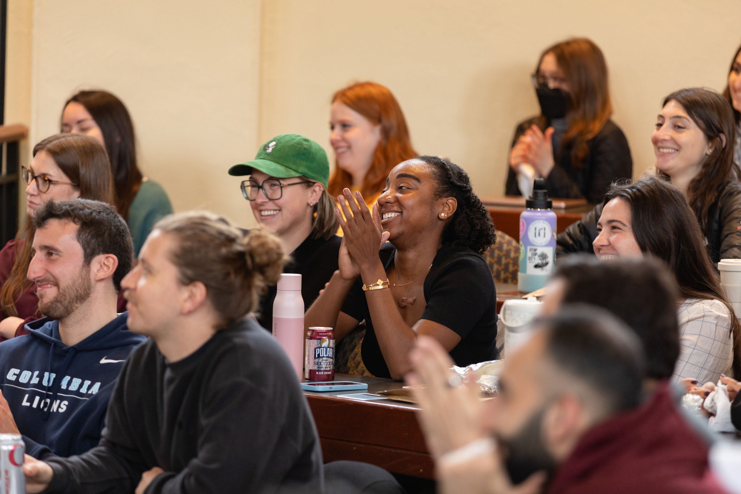 Students smiling while listening to a lecture
