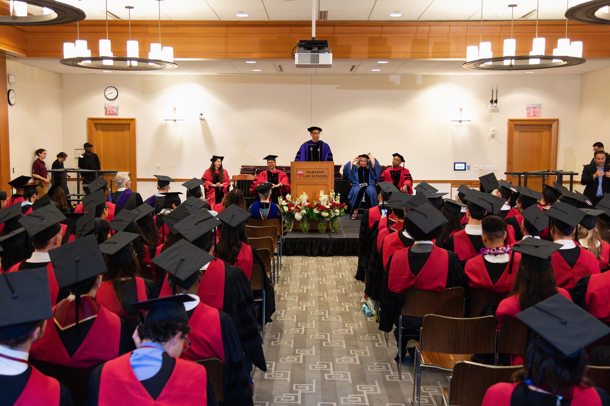 Dean Goldberg addresses rows of students in caps and gowns