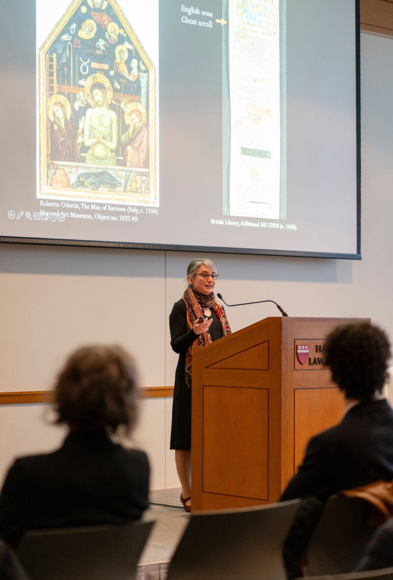 Liz Kamali speaking at a podium
