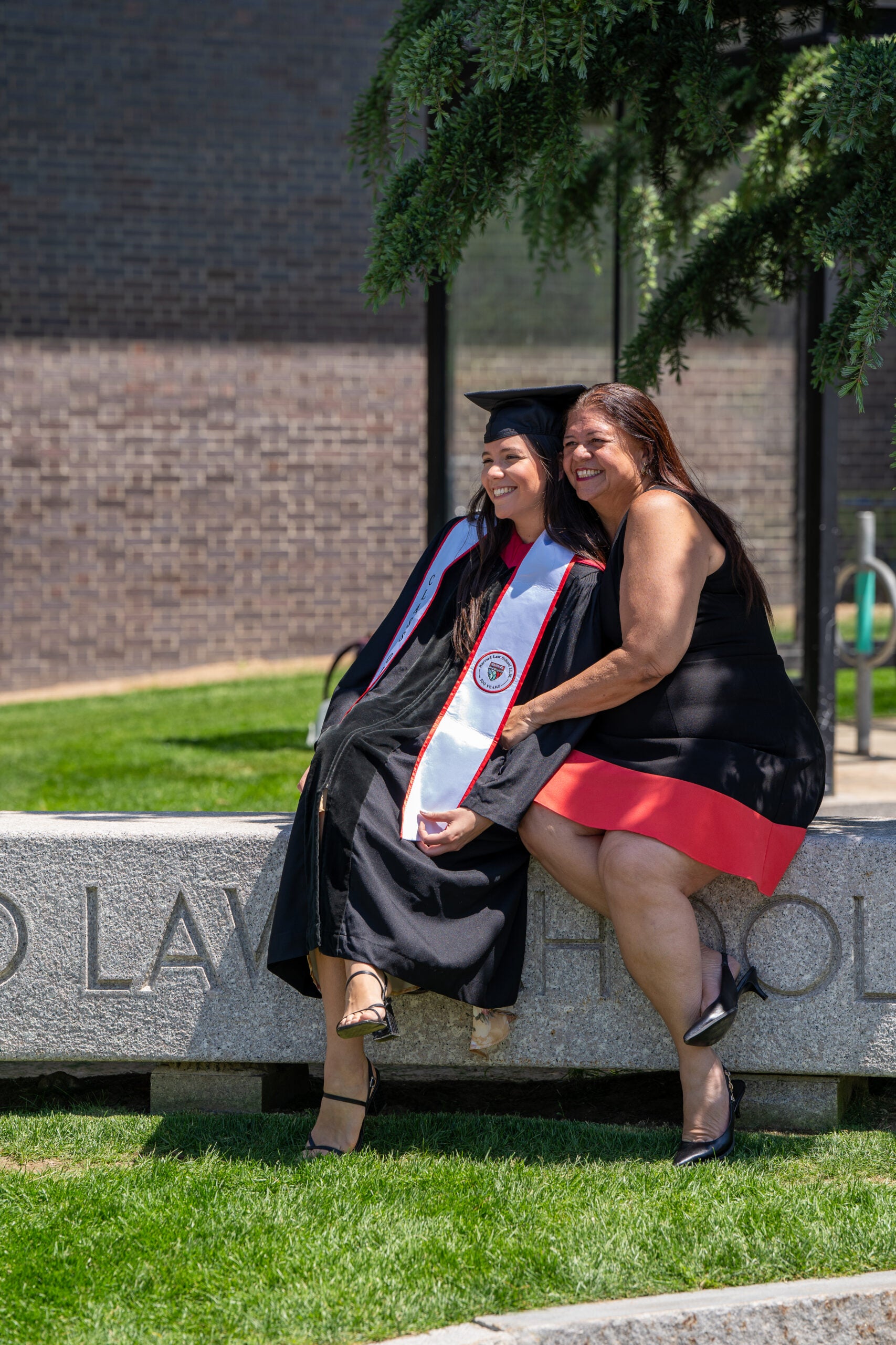 Mother and graduate daughter pose together
